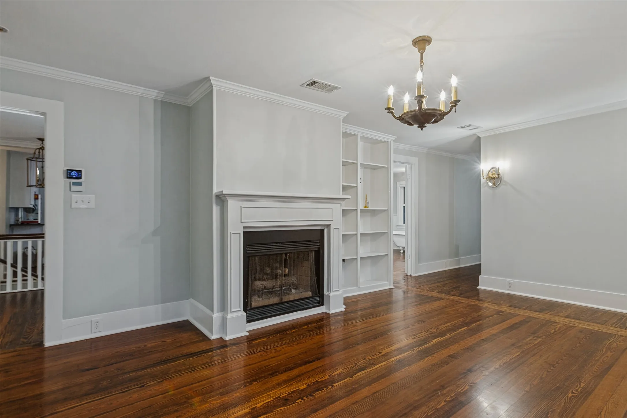 Primary suite with walk in closet, ensuite bathroom, built-in shelving, fireplace and dressing room
