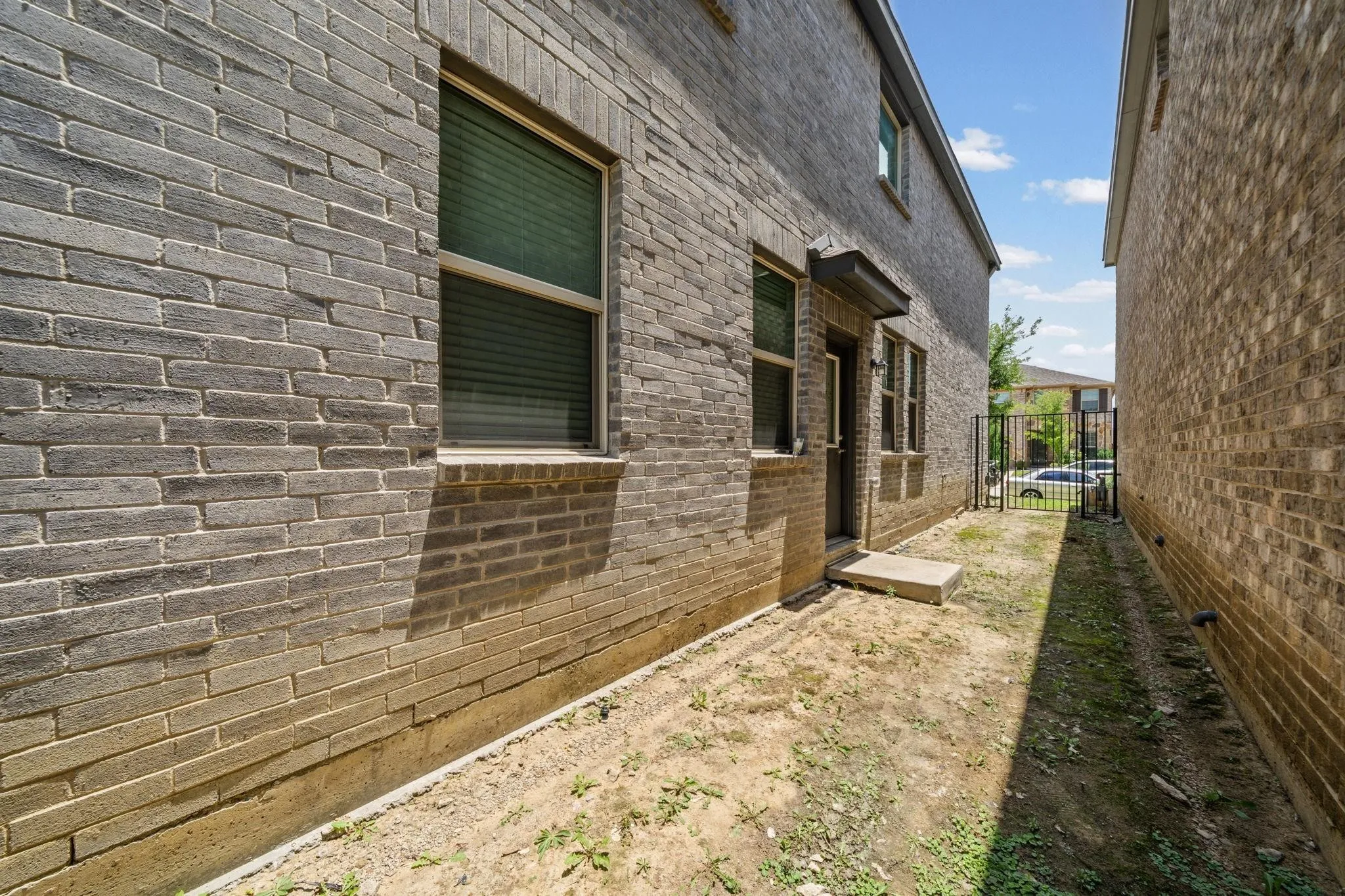 Brick exterior construction with an exterior door and a security gate