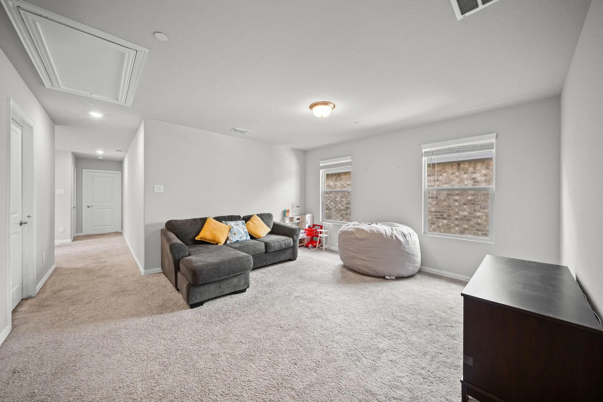 Carpeted room with recessed lighting and a flush mount light fixture