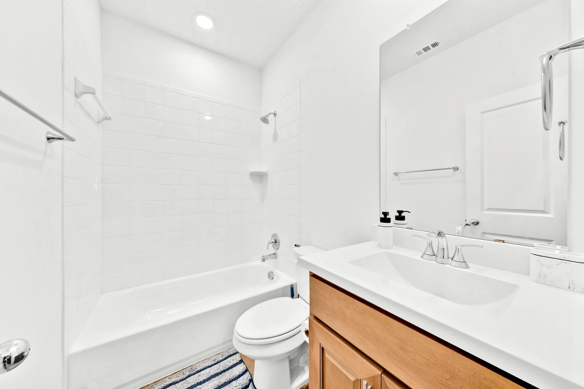 White subway tile shower surround with a built-in shelf