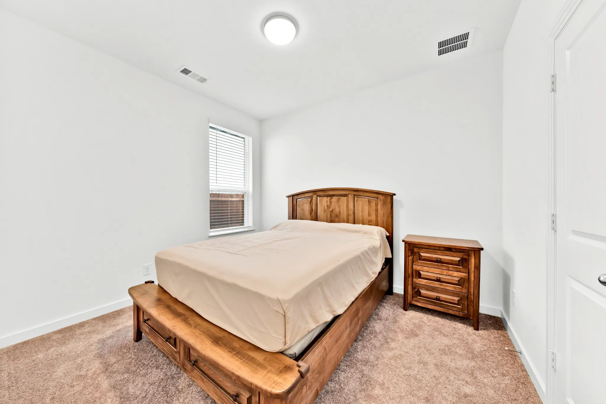 Carpeted flooring, window with blinds, and recessed lighting