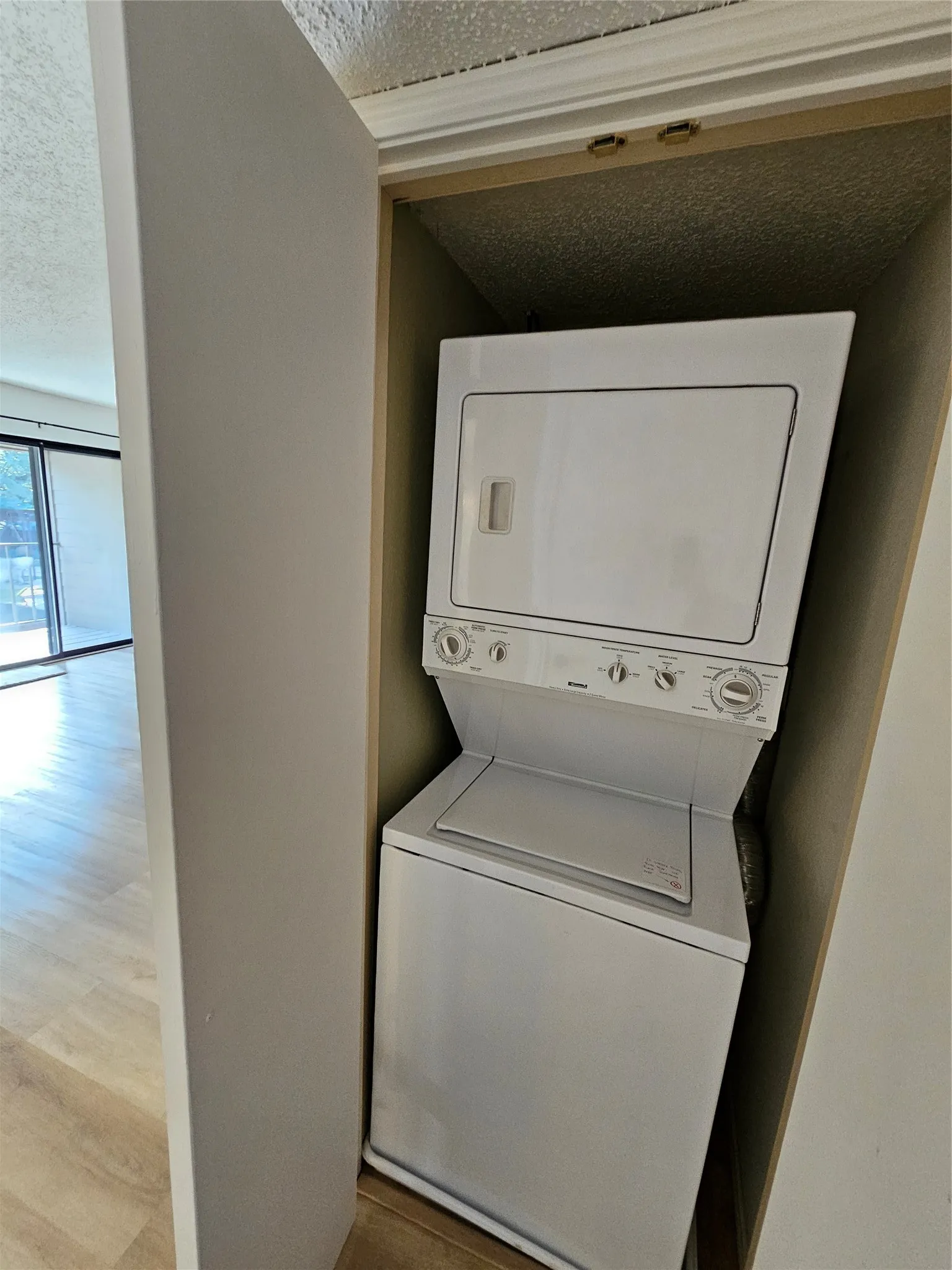 Laundry featuring stacked washer/dryer
