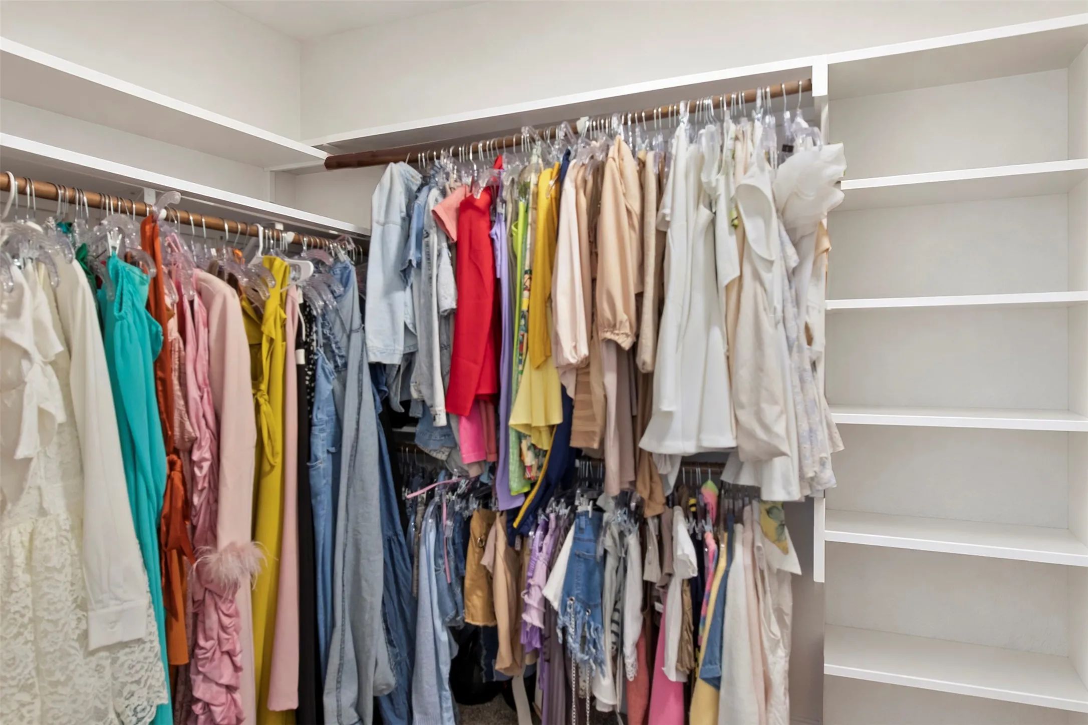 Built-in closet system with multiple shelving units and hanging rods