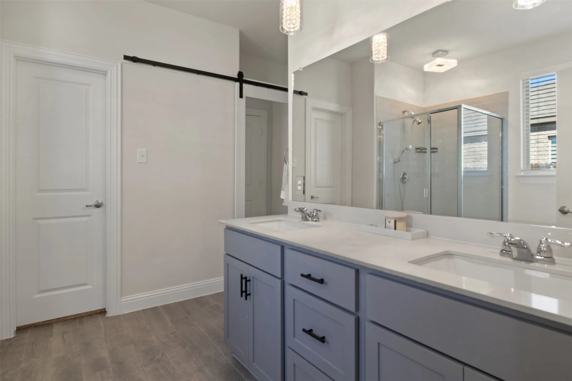 Dual vanity with light gray cabinetry, white countertops, and chrome fixtures