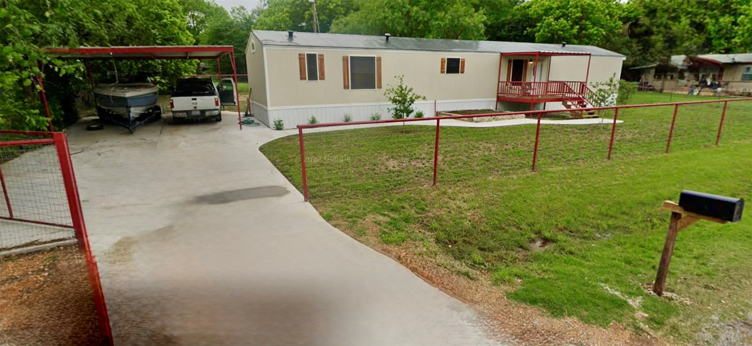 Concrete driveway leading to a covered carport