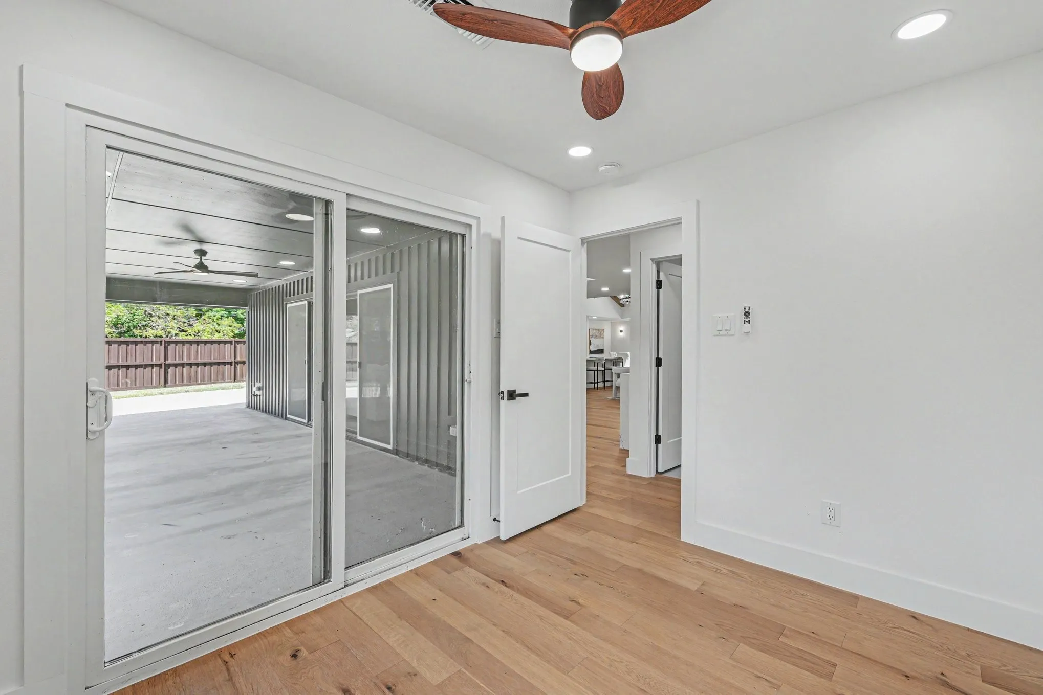 Wood-finish flooring, recessed lighting, and a modern ceiling fan
