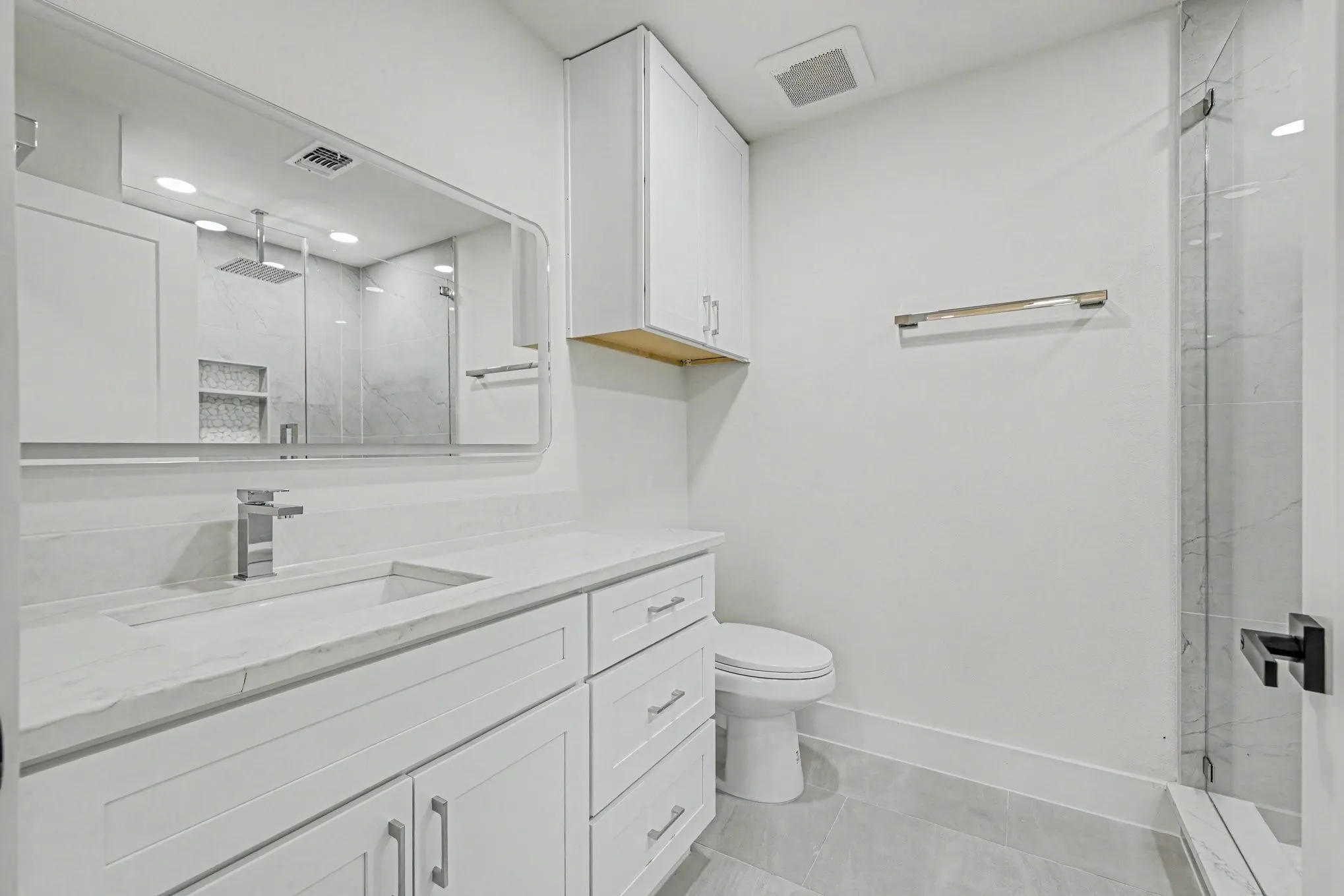 White vanity with an integrated rectangular sink and chrome faucet
