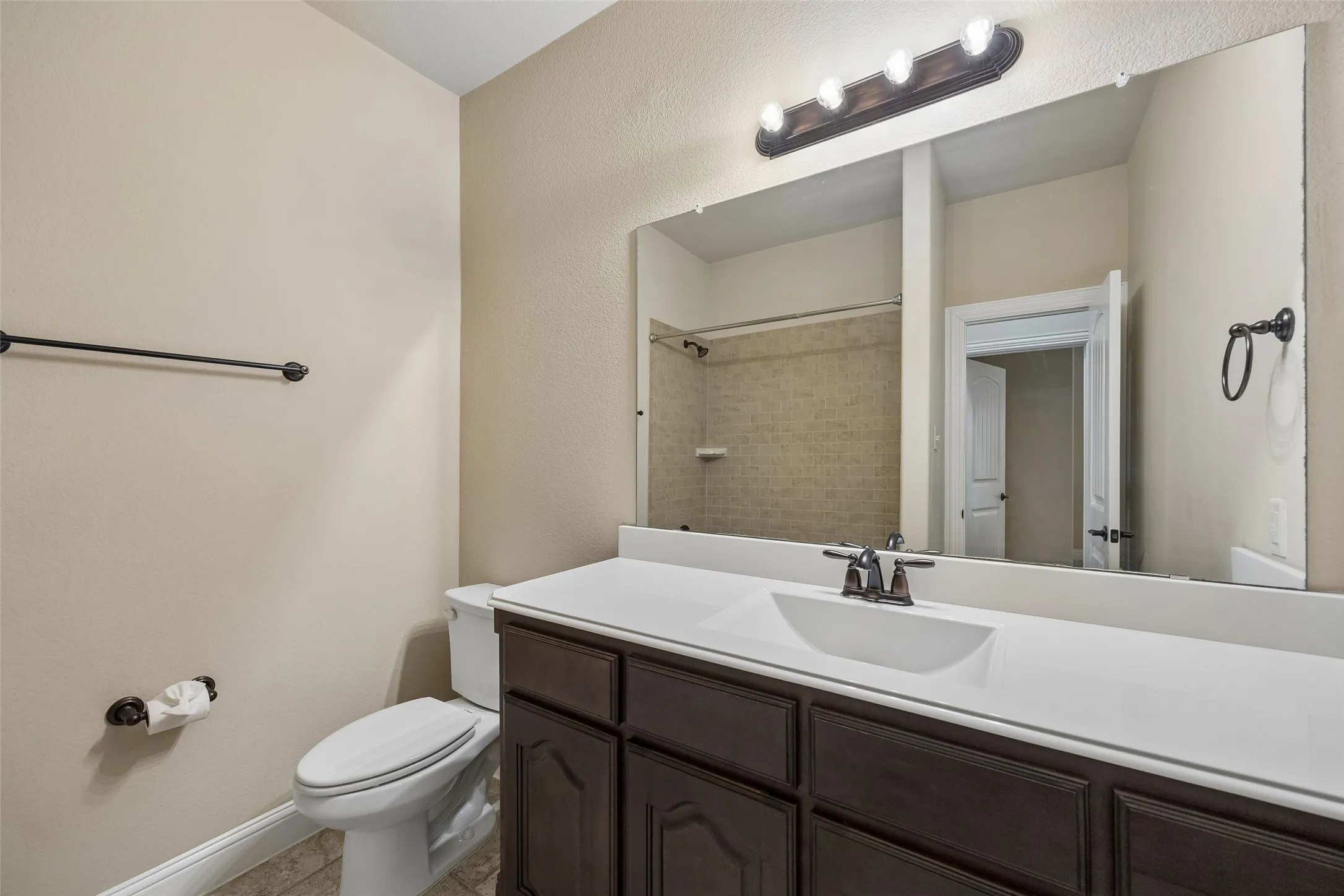 Dark wood-finish vanity with white countertop and integrated sink