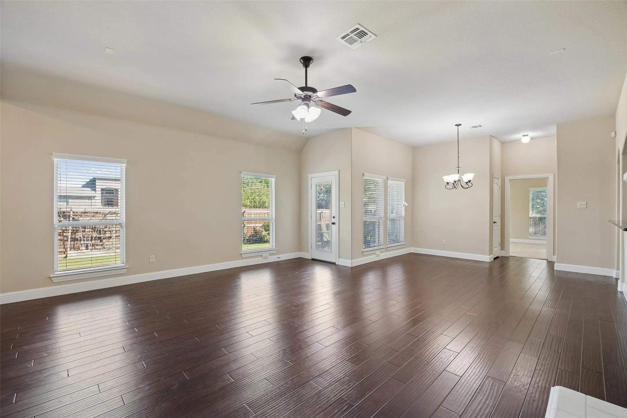 High ceilings with a ceiling fan and engineered wood