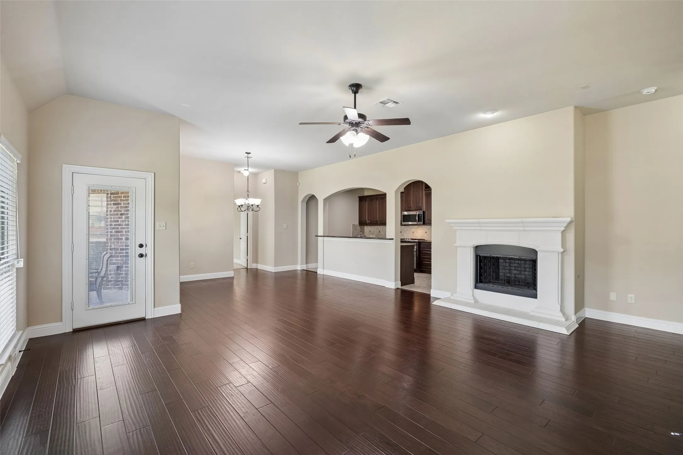 Spacious living area featuring engineered wood flooring open to the breakfast area