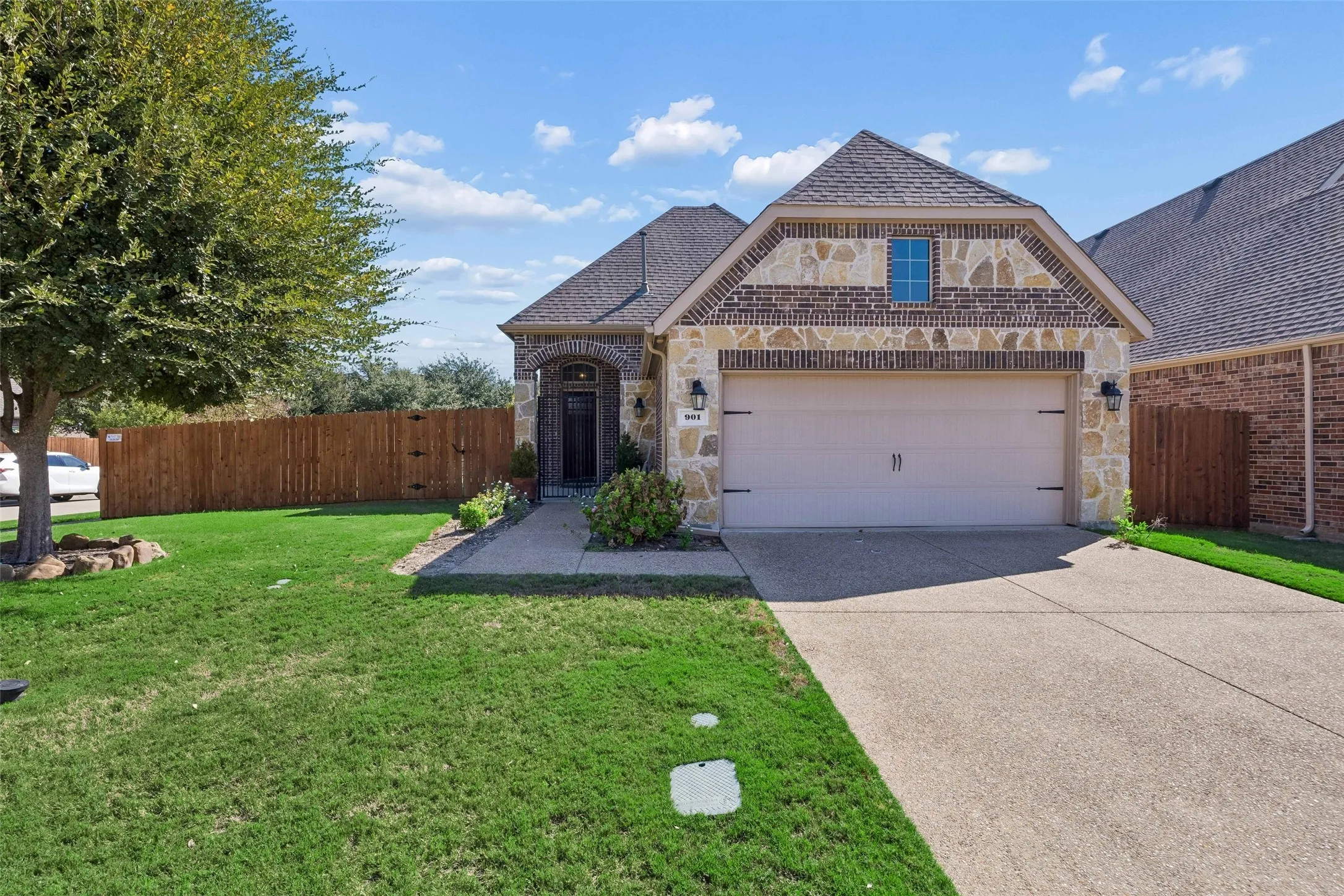 Brick and stone exterior with an arched entry into a covered courtyard.