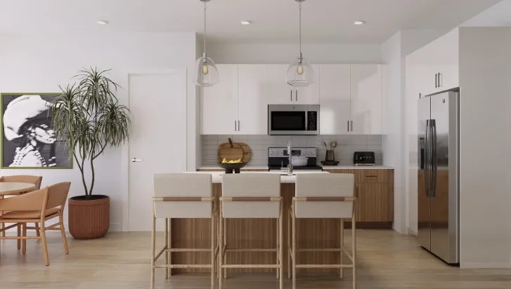 Kitchen featuring tasteful backsplash, light countertops, appliances with stainless steel finishes, hanging light fixtures, and a kitchen island with sink