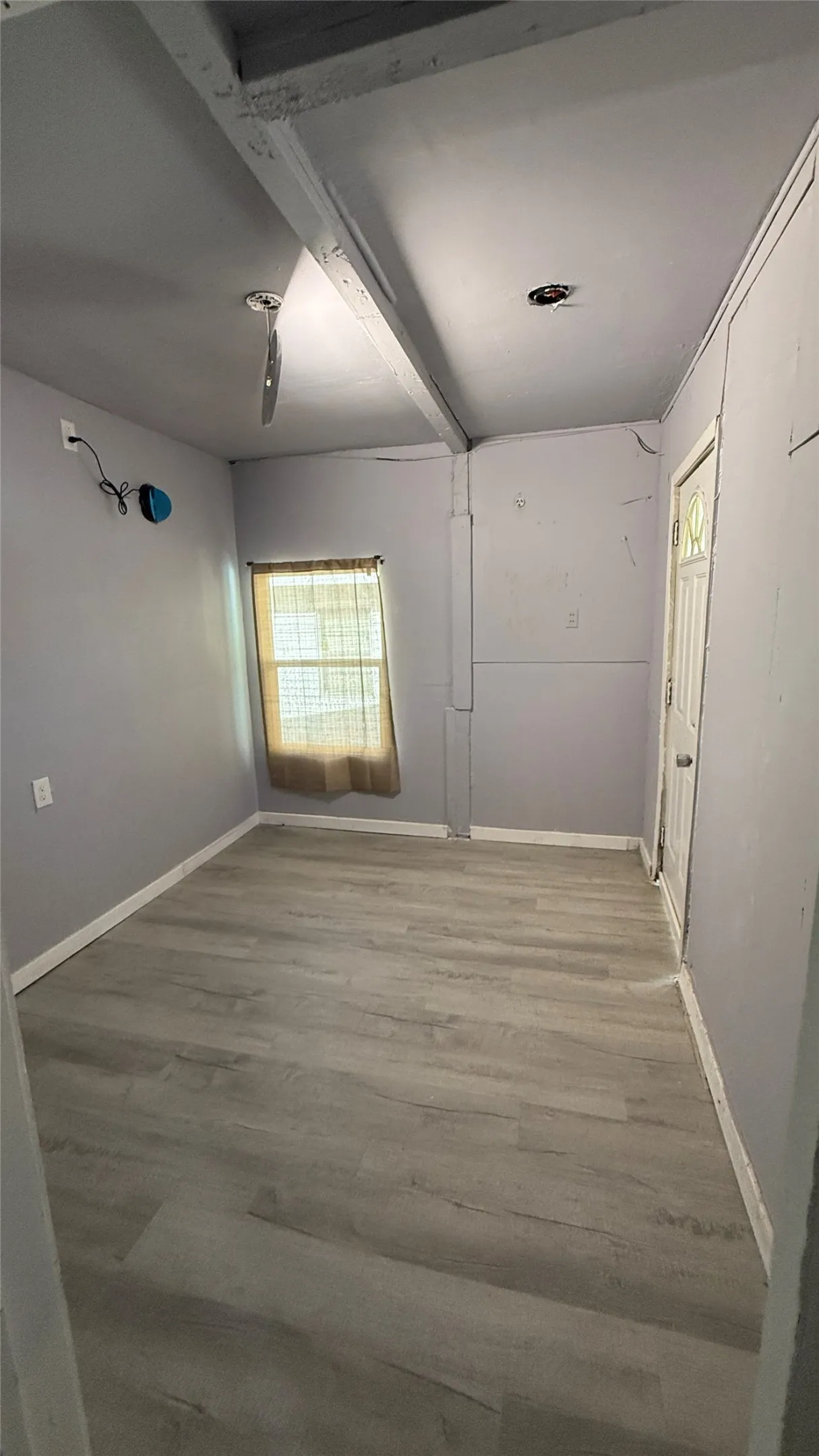 Wood-finish flooring with white baseboards