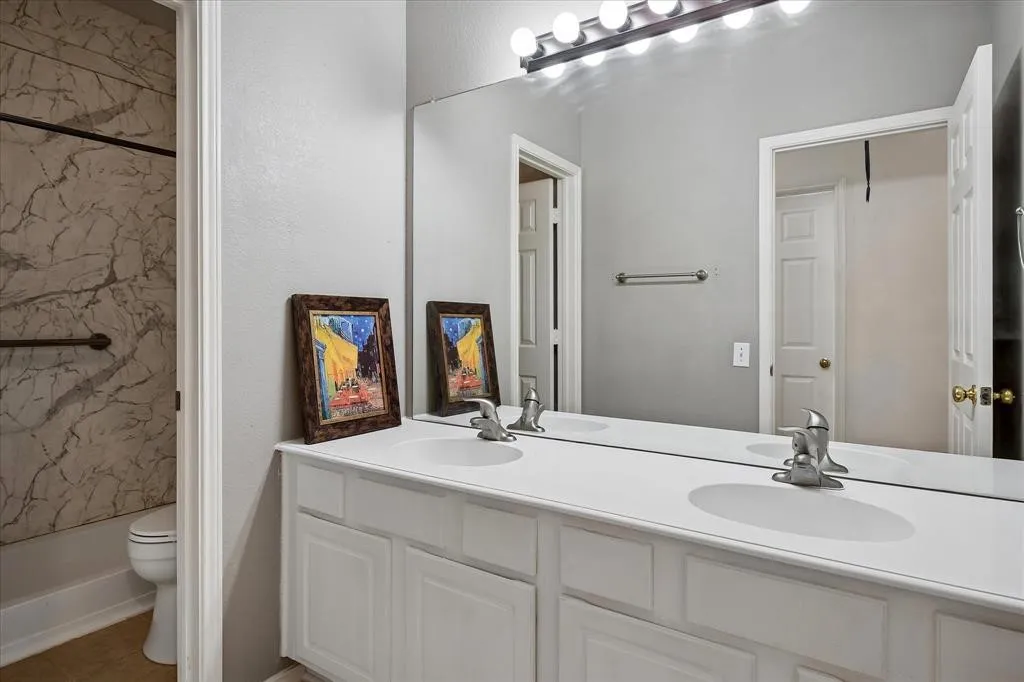 Dual vanity with white cabinetry and built-in sinks