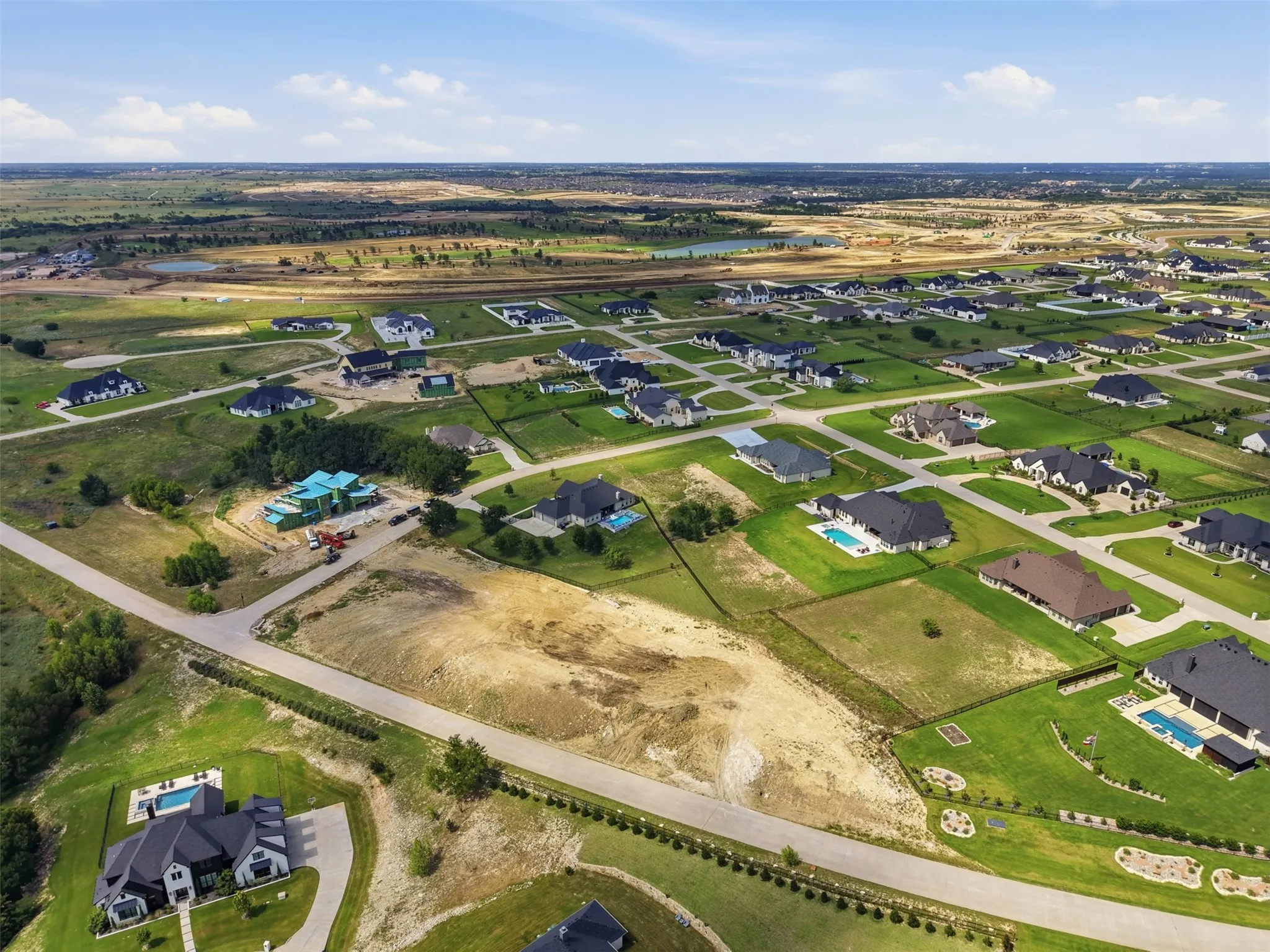 Expansive residential development featuring large plots, established homes with private pools, and new construction