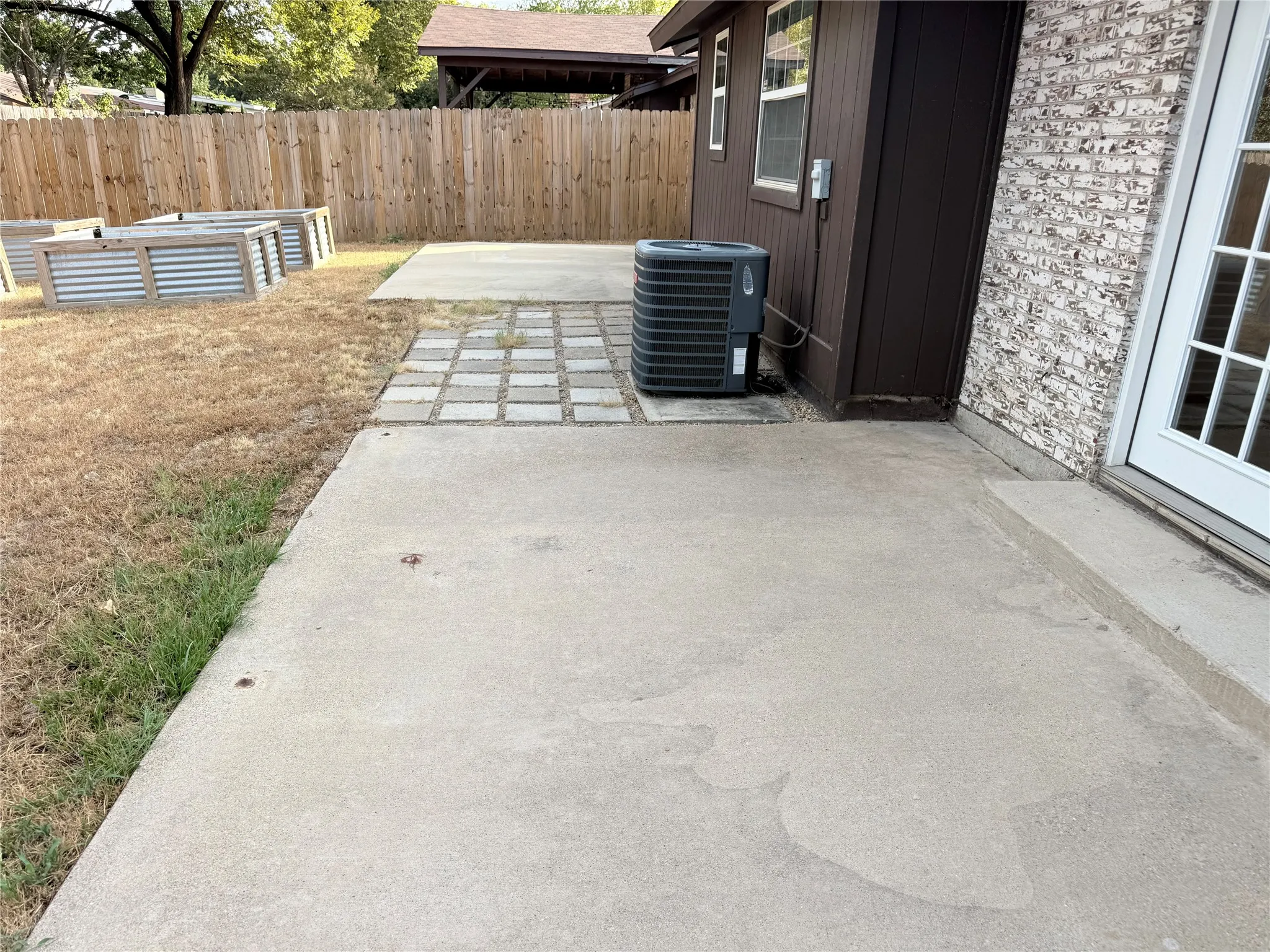 Two patios, plus it's ready for you to grow your own veggies.