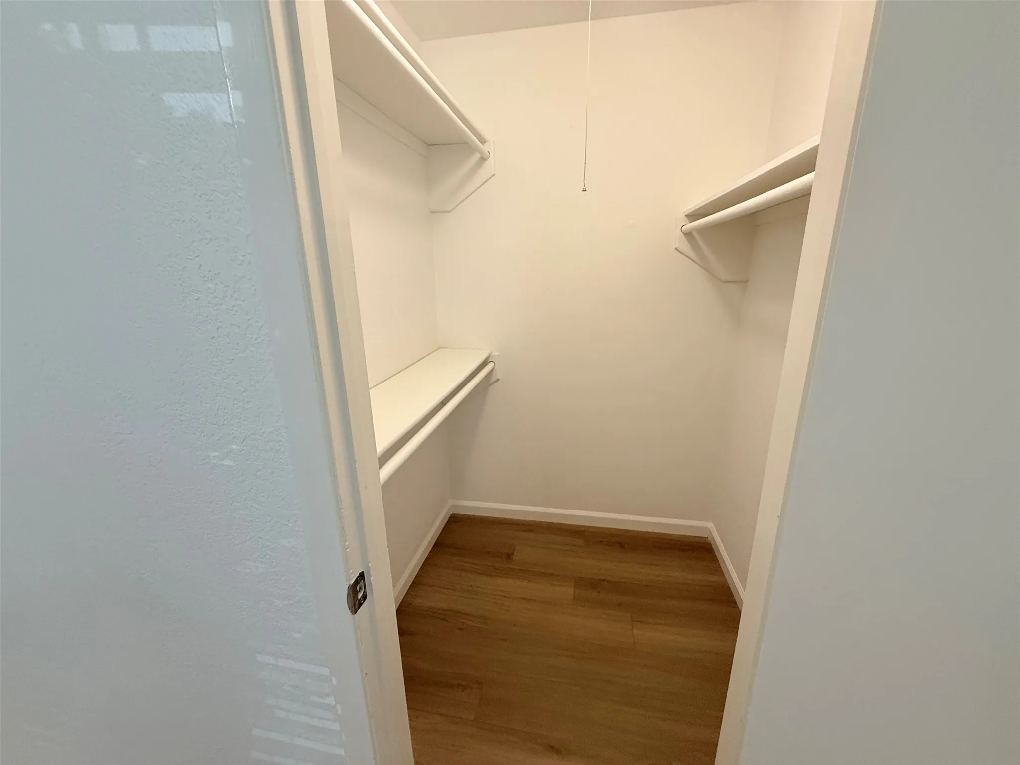 Master closet with lots of hanging space.
