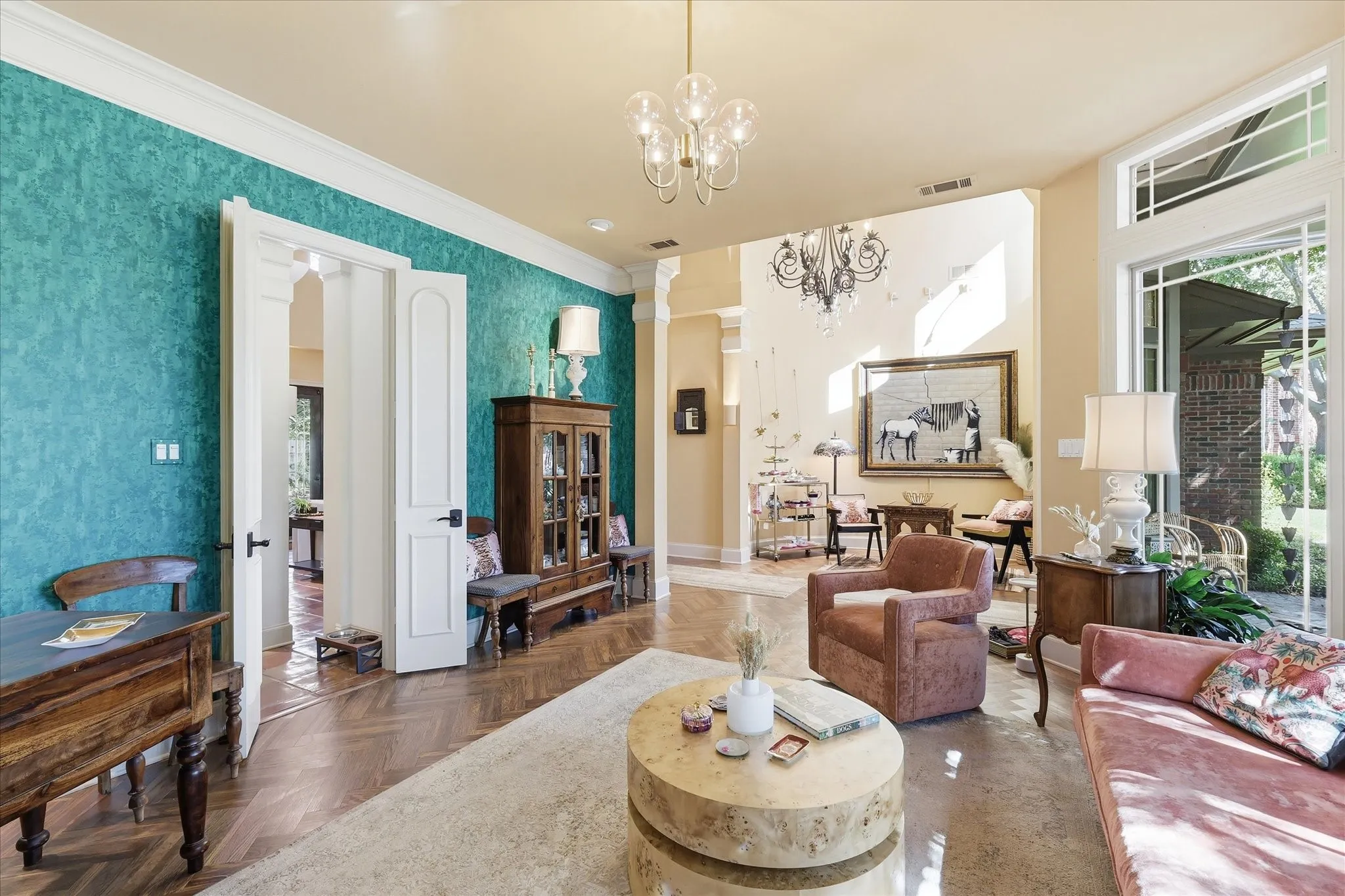 Herringbone wood-finish flooring, decorative wall treatment, transom windows, and an arched doorway
