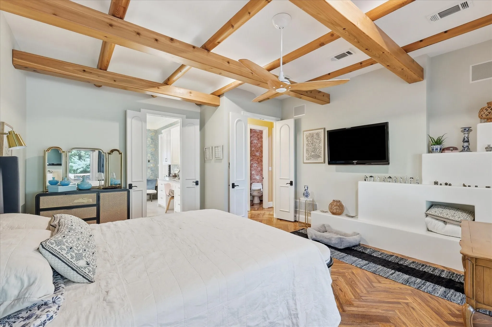 Wood-finish herringbone flooring with exposed wood beam ceiling