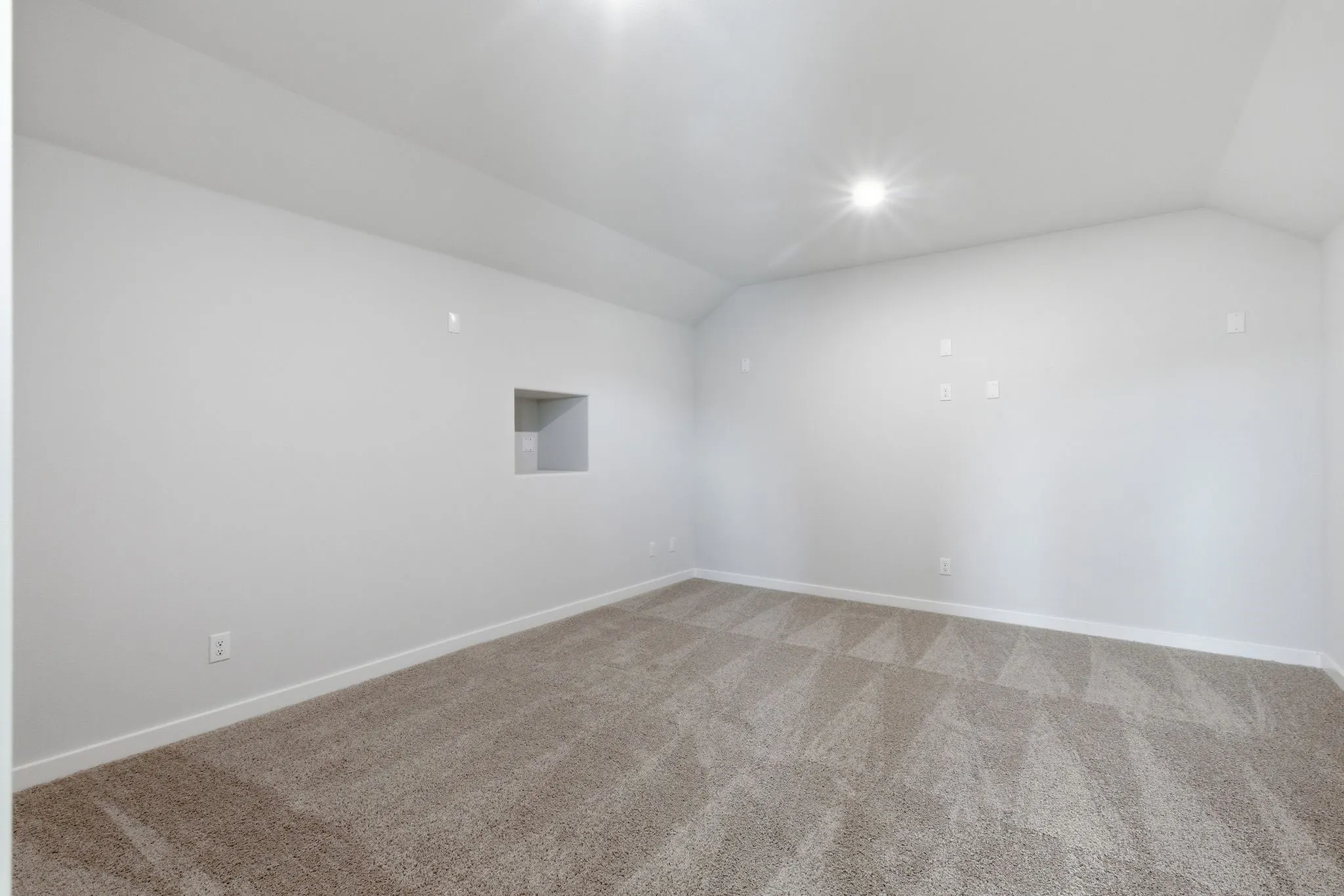 Recessed wall niche, sloped ceiling, and recessed lighting