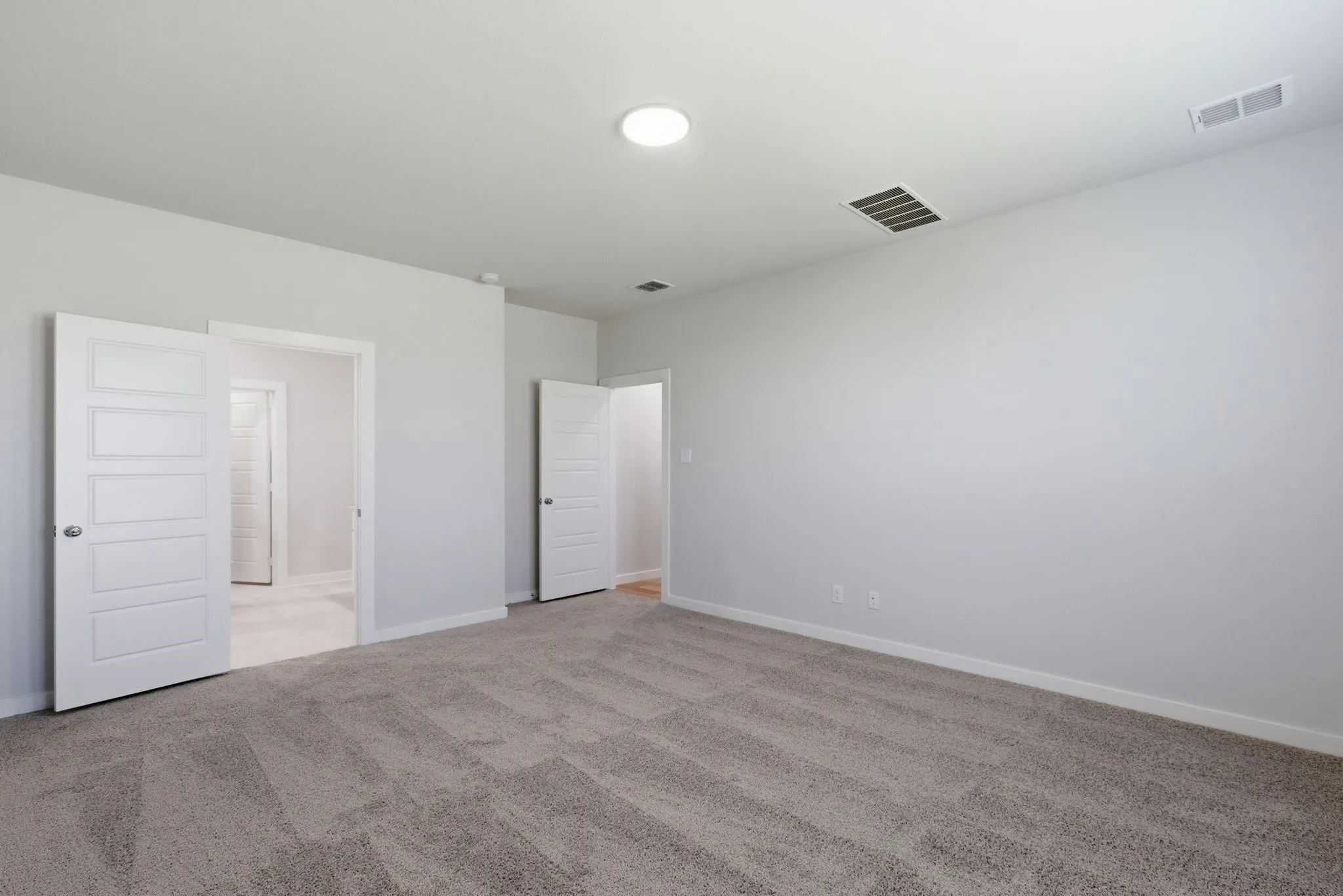 Plush carpeting and white paneled doors