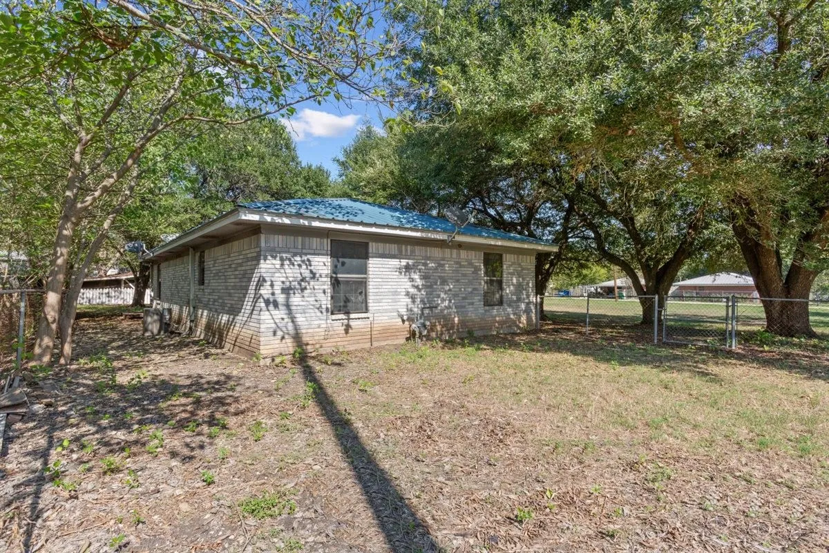 Stone exterior with a blue metal roof