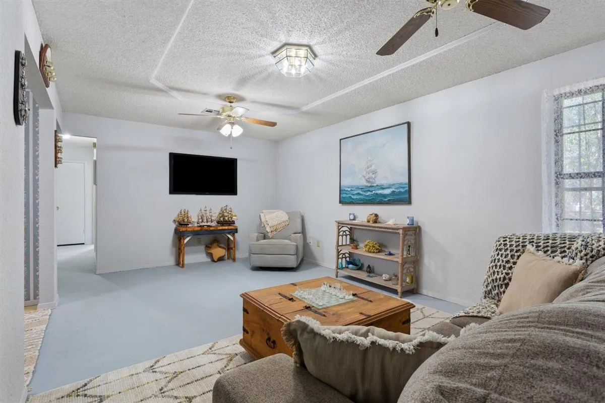 Recessed lighting, ceiling fans, and window with natural light
