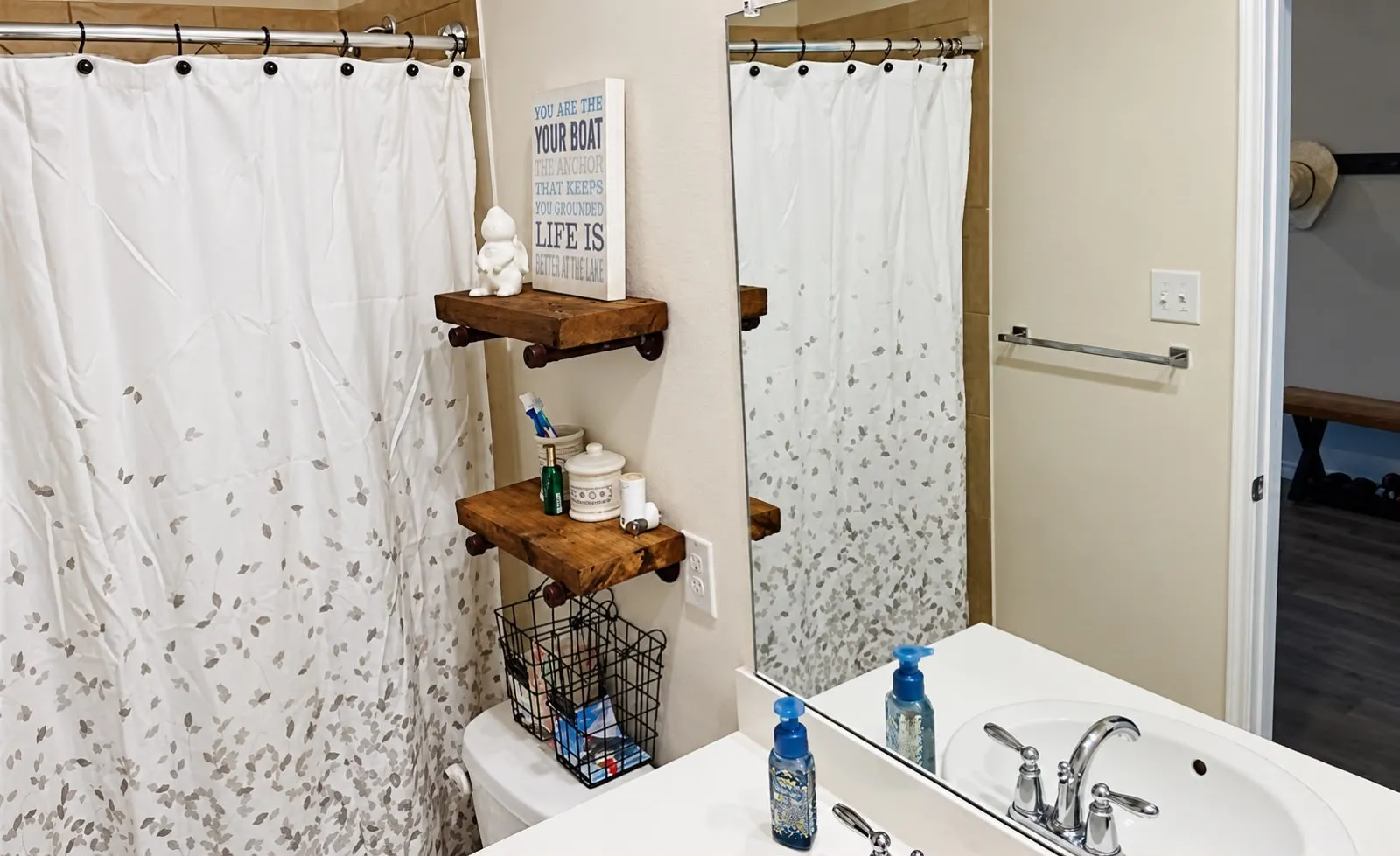 Vanity with integrated sink, chrome faucet, and expansive wall mirror