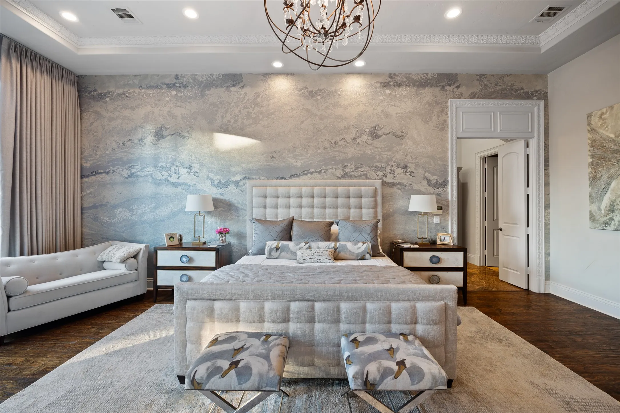 Crown molding, recessed lighting, wood-finish flooring, and a decorative chandelier