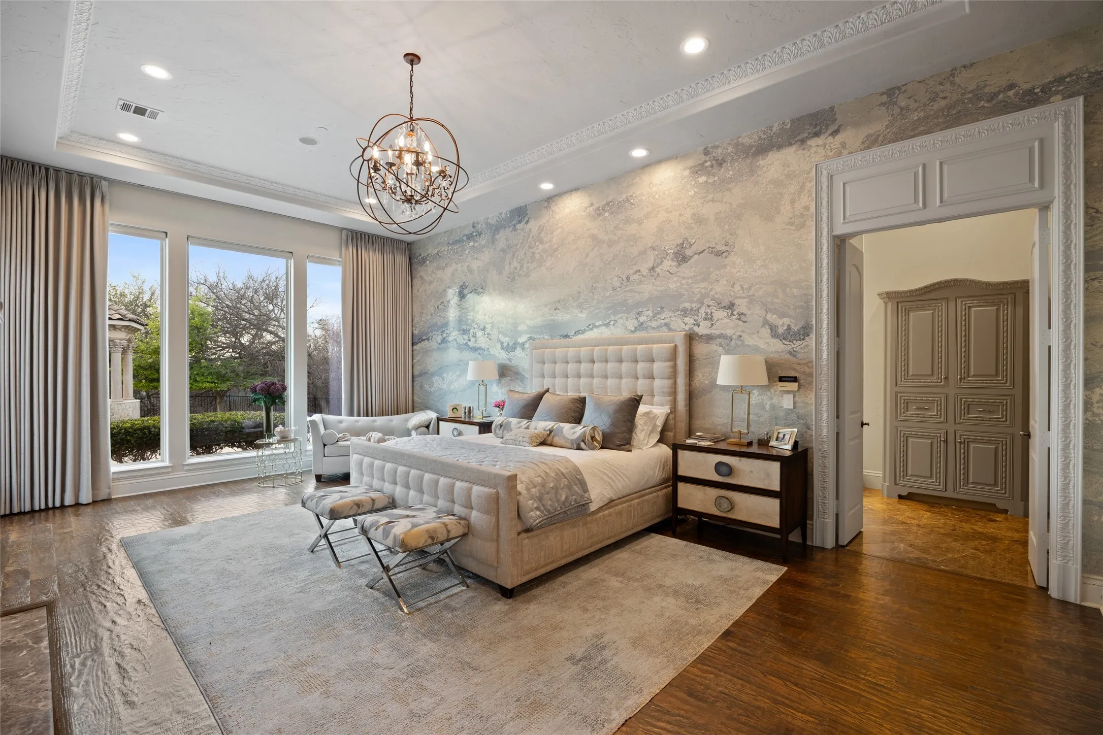 Hardwood-finish flooring, recessed lighting, decorative crown molding, and an ornate chandelier