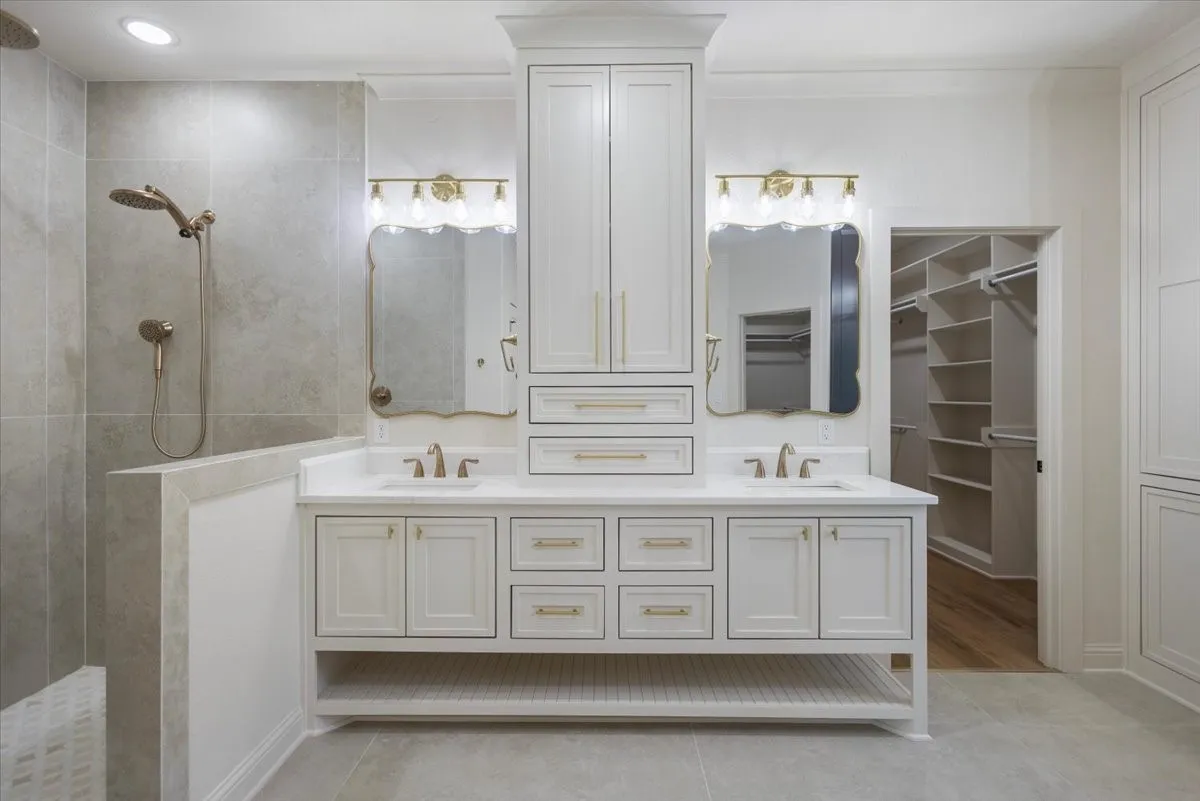 Dual vanity with white cabinetry and integrated sinks