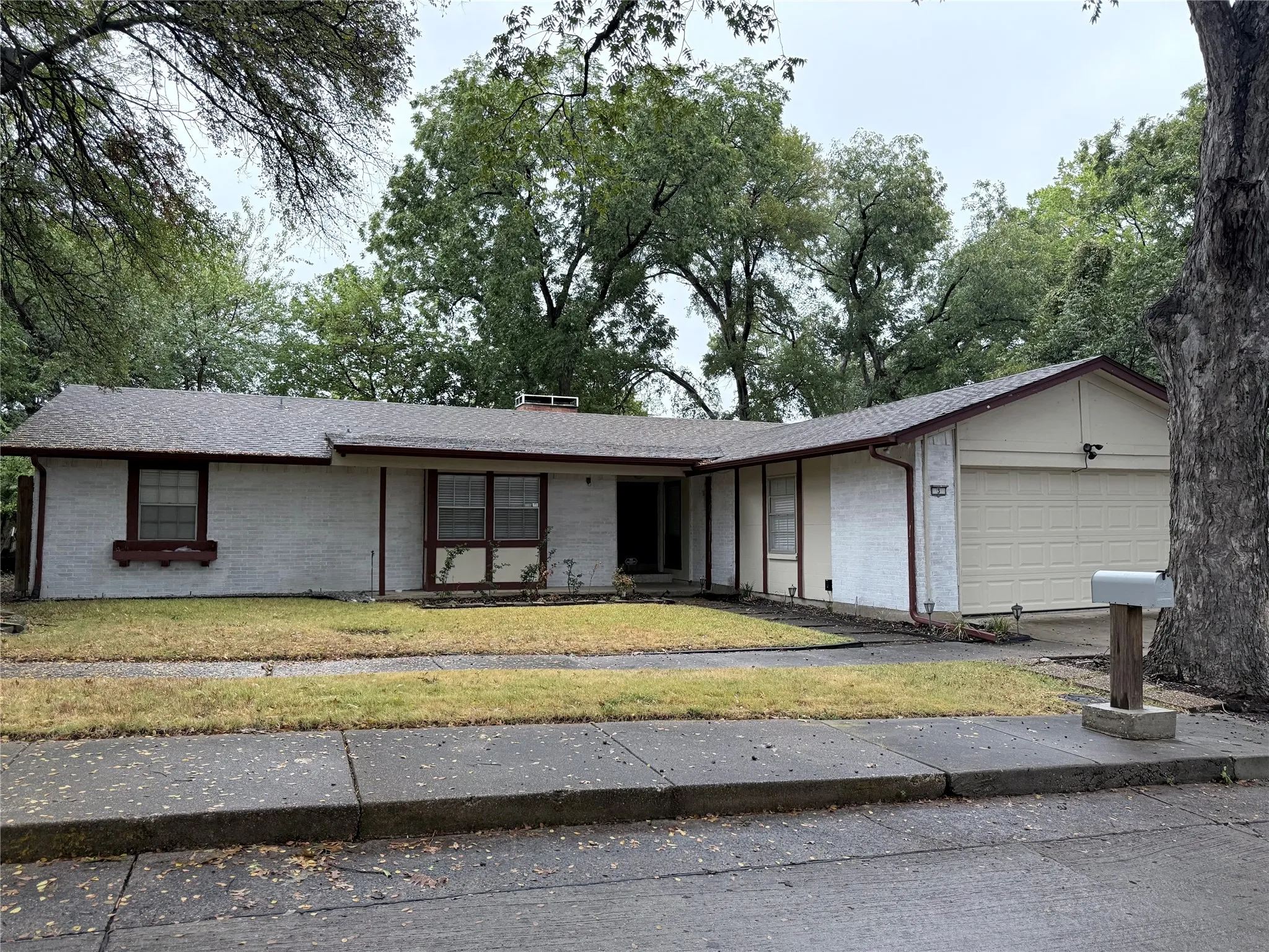 Exterior featuring a stucco finish, attached garage, and a mailbox
