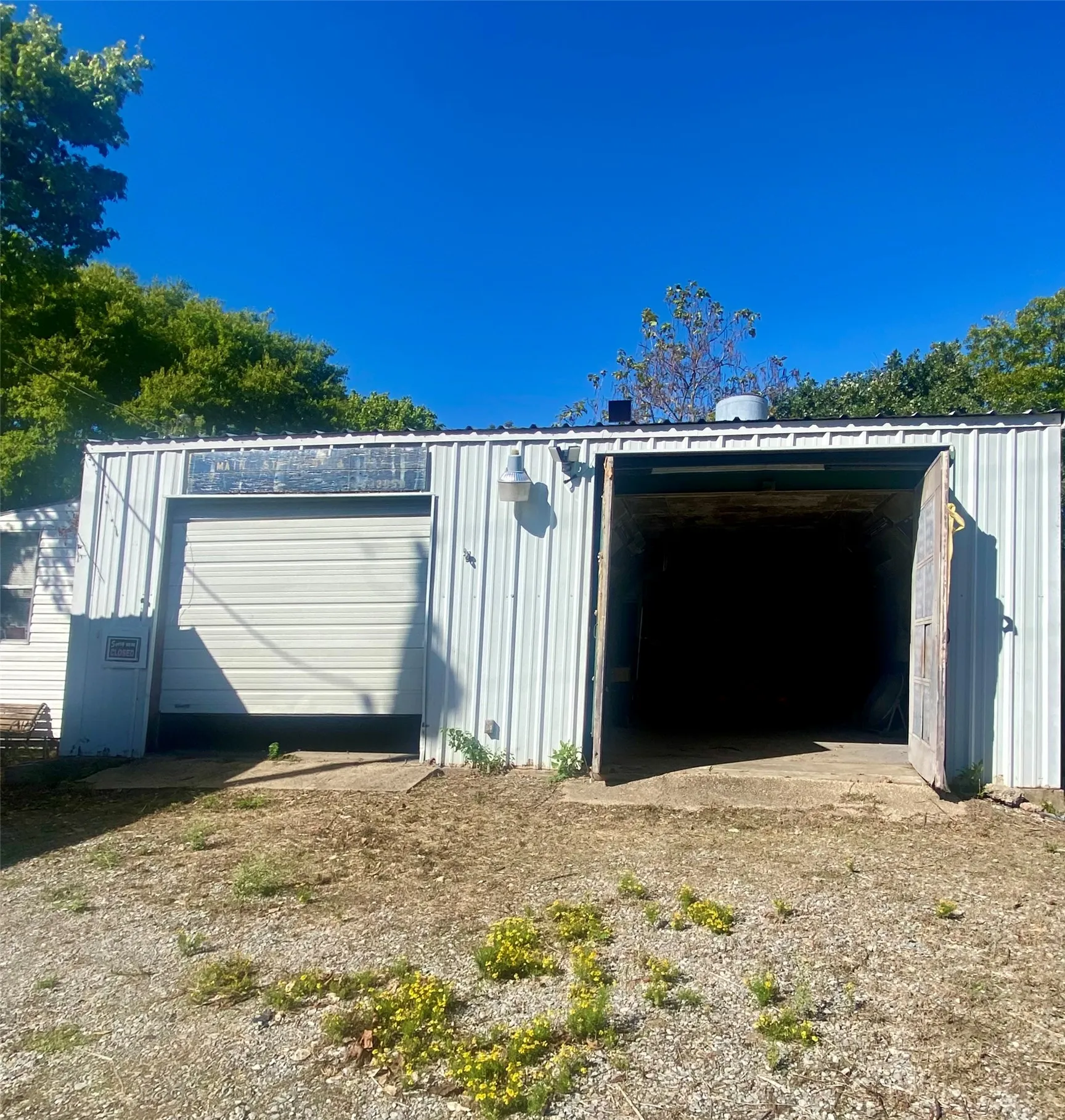 Front of garage with double doors on Main Street.  Open door is paint booth.