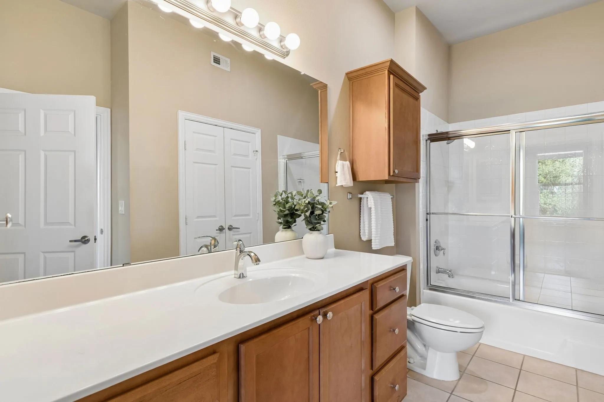 A bright, welcoming bathroom with a full tub and shower combination.