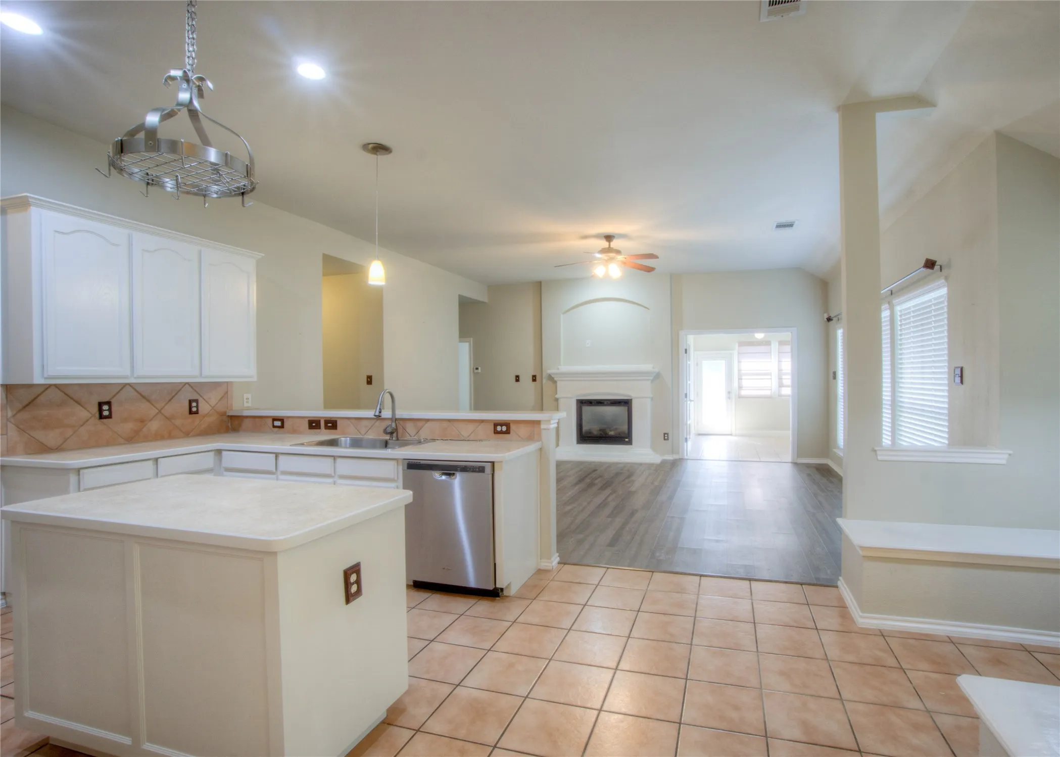 Kitchen featuring white cabinetry, a kitchen island, and stainless steel appliances