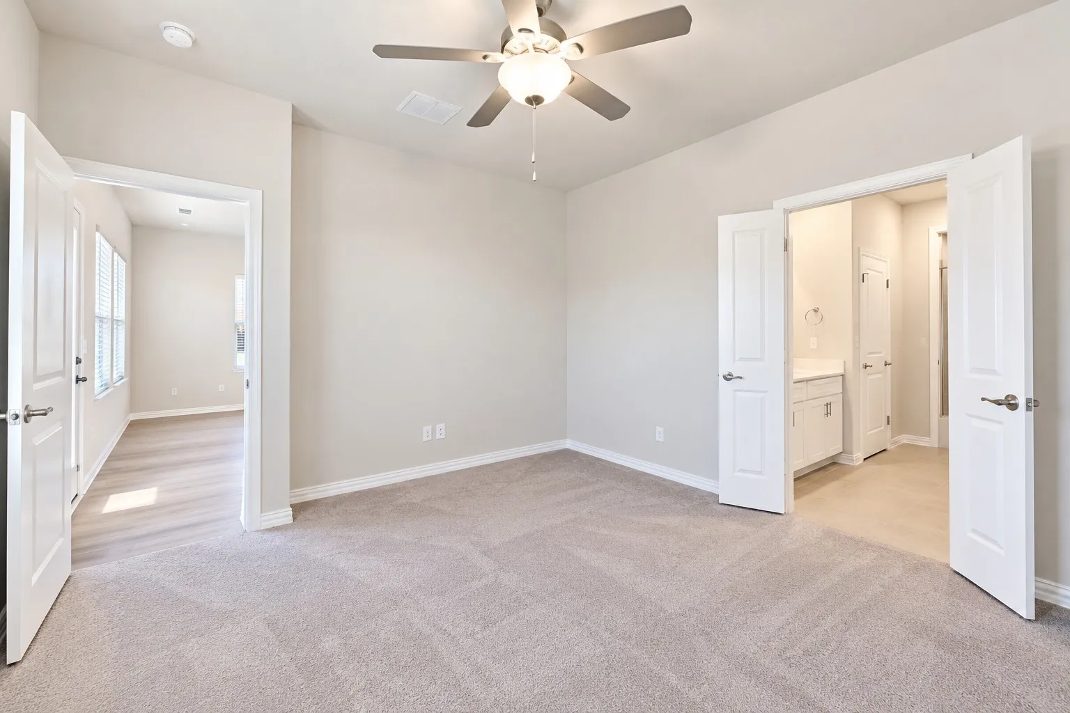 Carpeted room featuring a ceiling fan, recessed lighting, and a white vanity with a rectangular sink