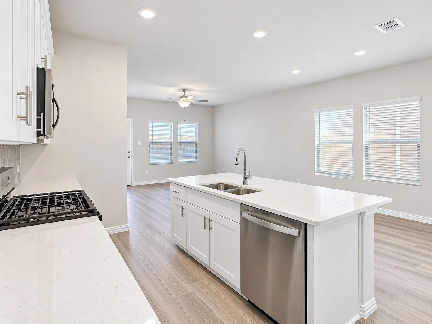 Kitchen island with a double basin sink and stainless steel dishwasher