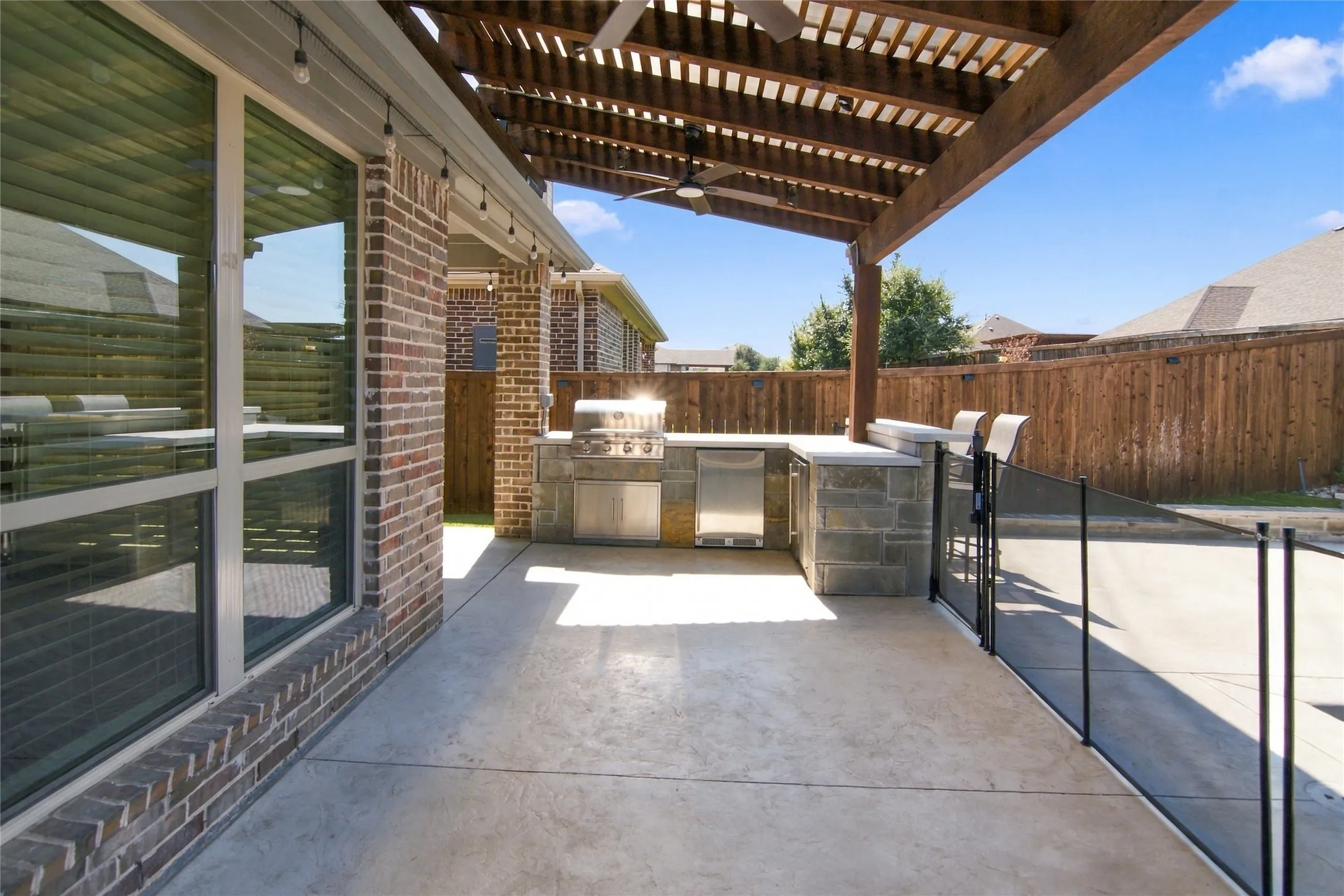 Extended patio with covered pergola and stamp concrete decking