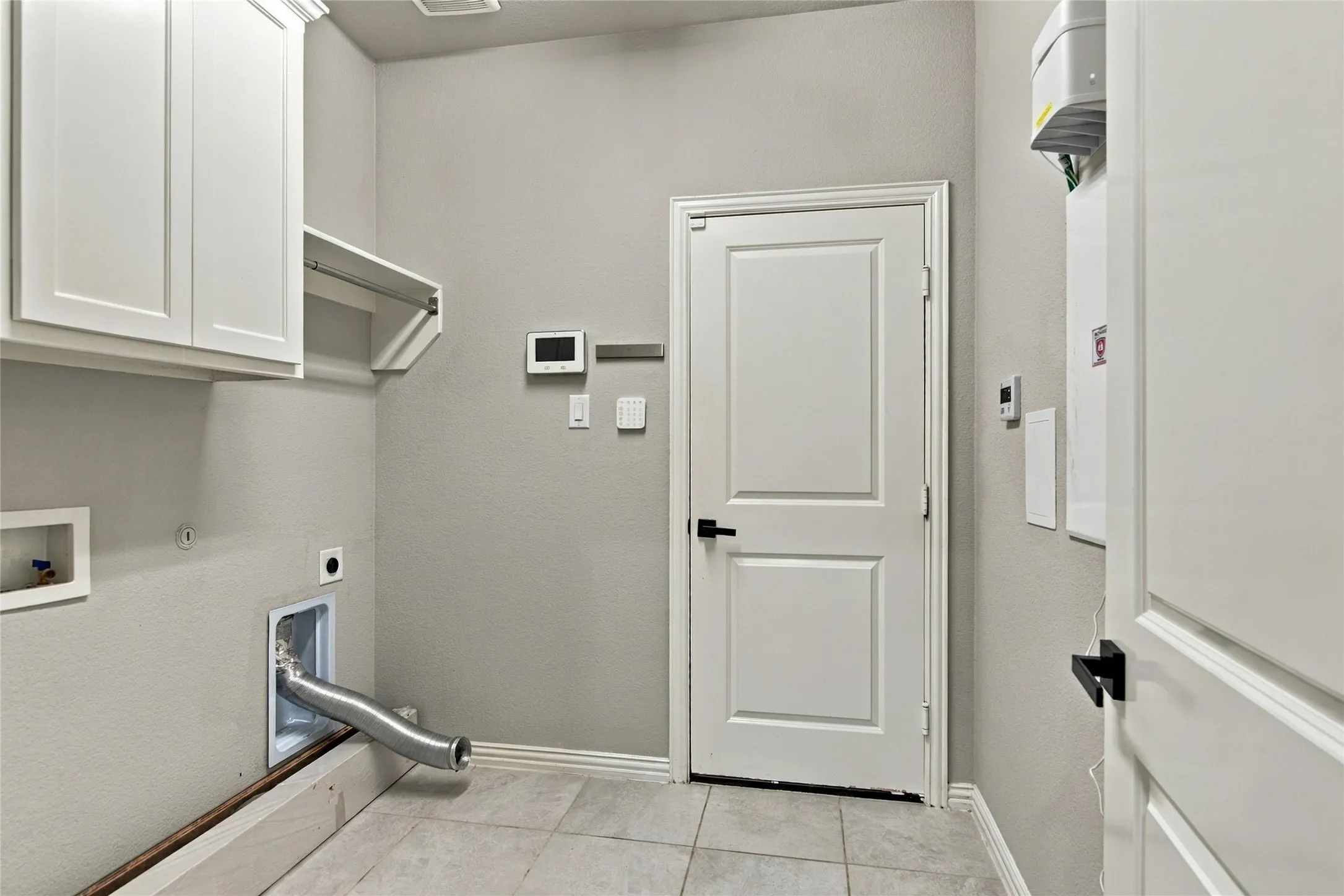 Full size Laundry room with cabinets and shelf