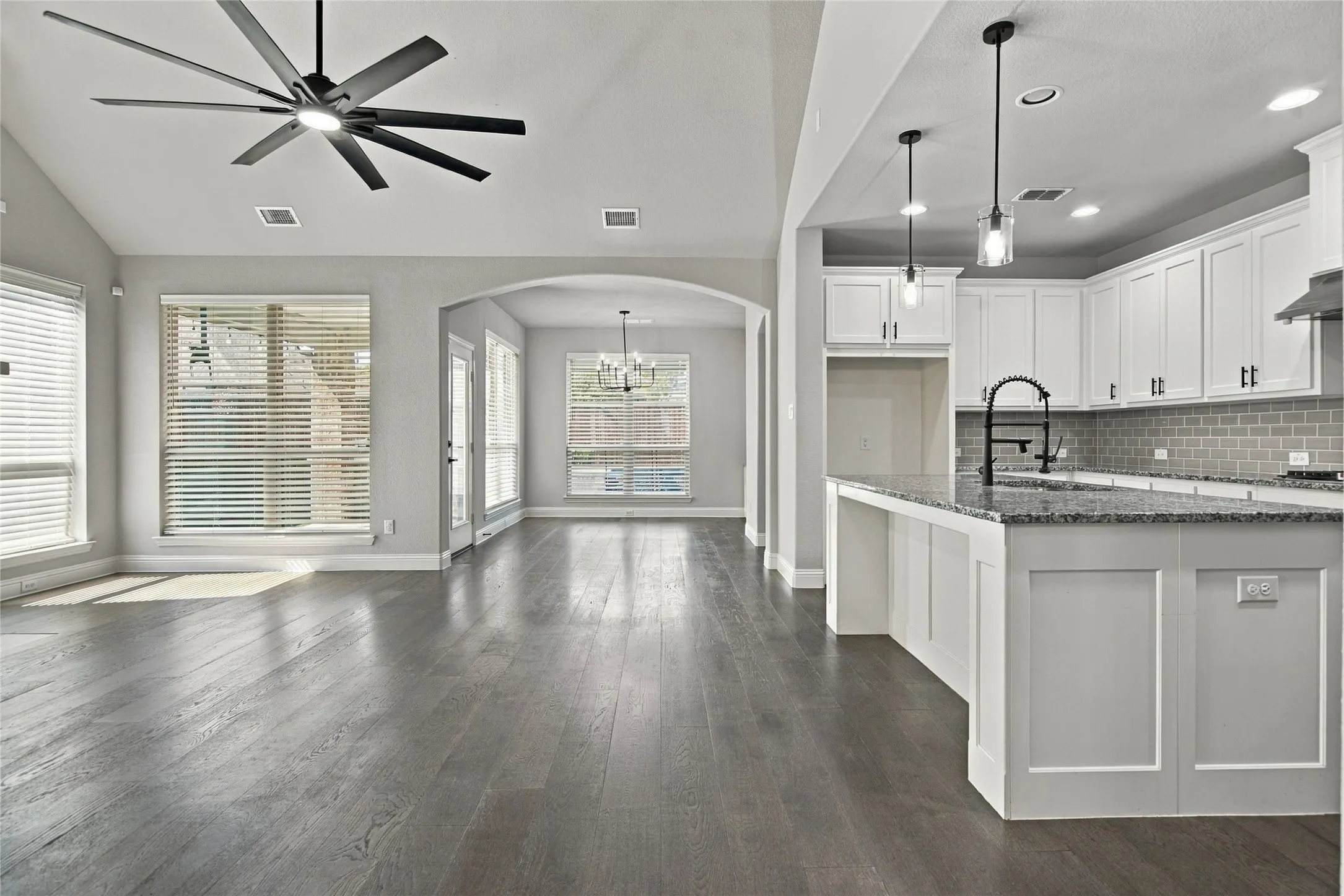 Kitchen, Dining room and Family room surrounded with a wall of windows