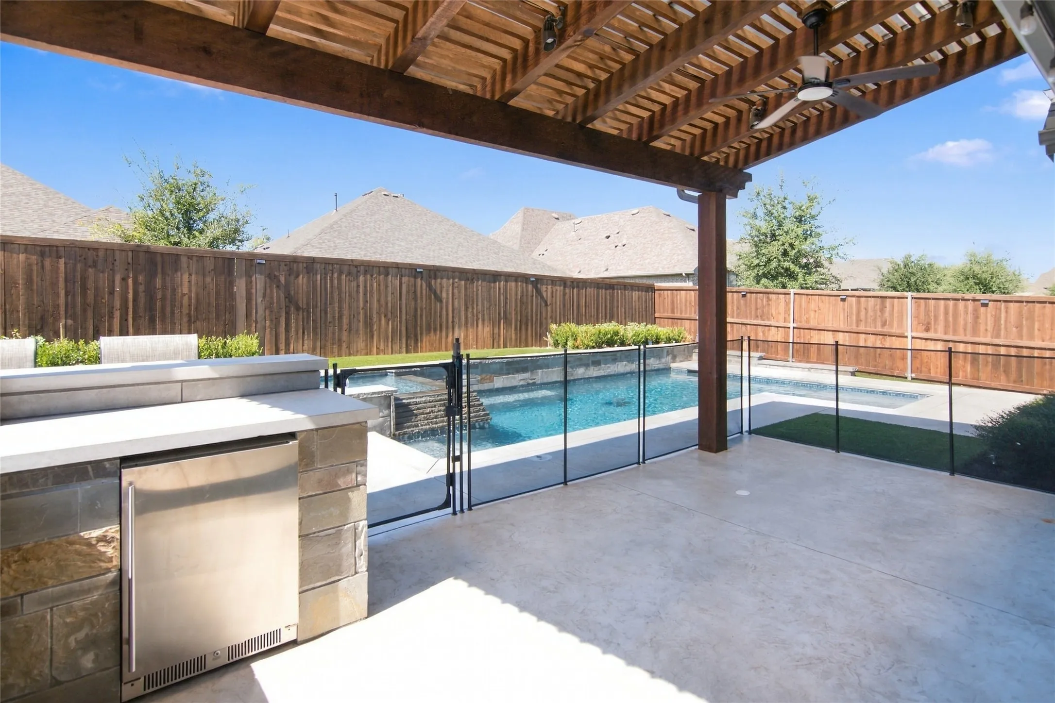 Custom arbor, outdoor lighting, and pergola with extended patio
