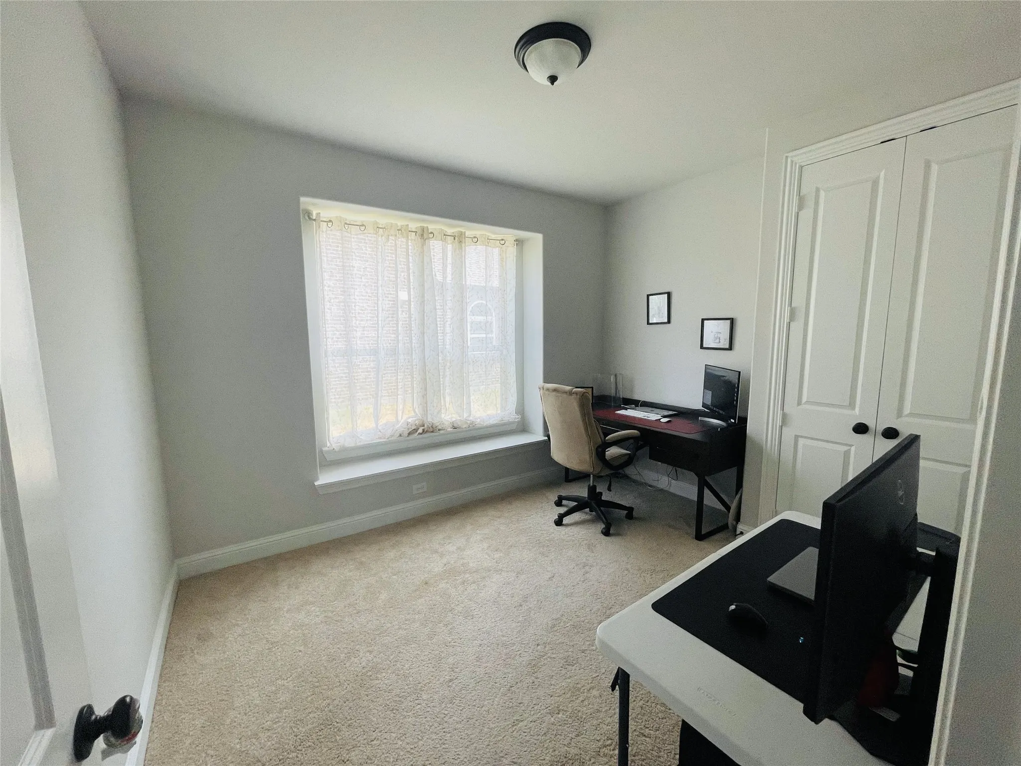 Office space featuring carpet flooring and a wealth of natural light