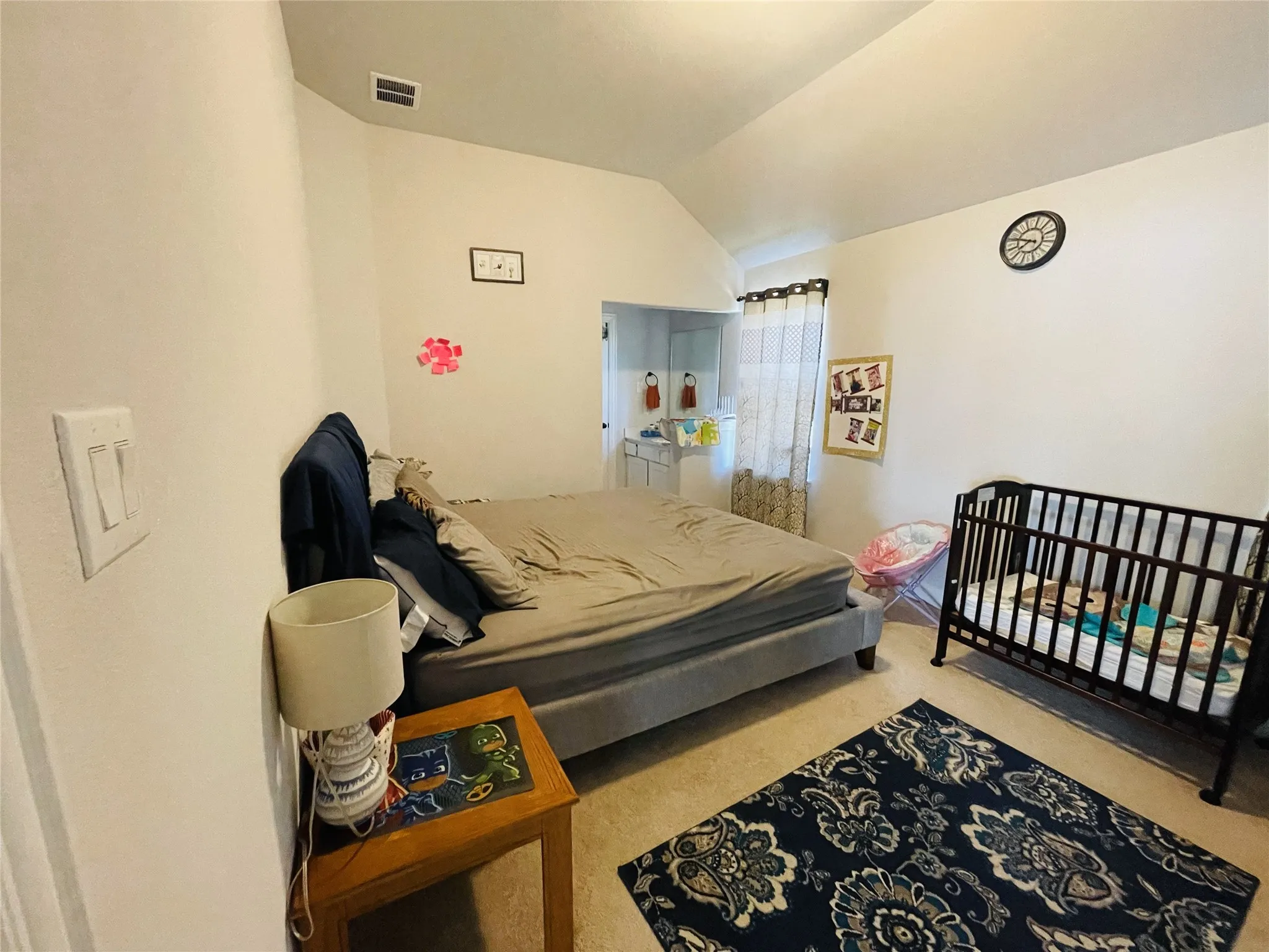 Carpeted bedroom featuring lofted ceiling