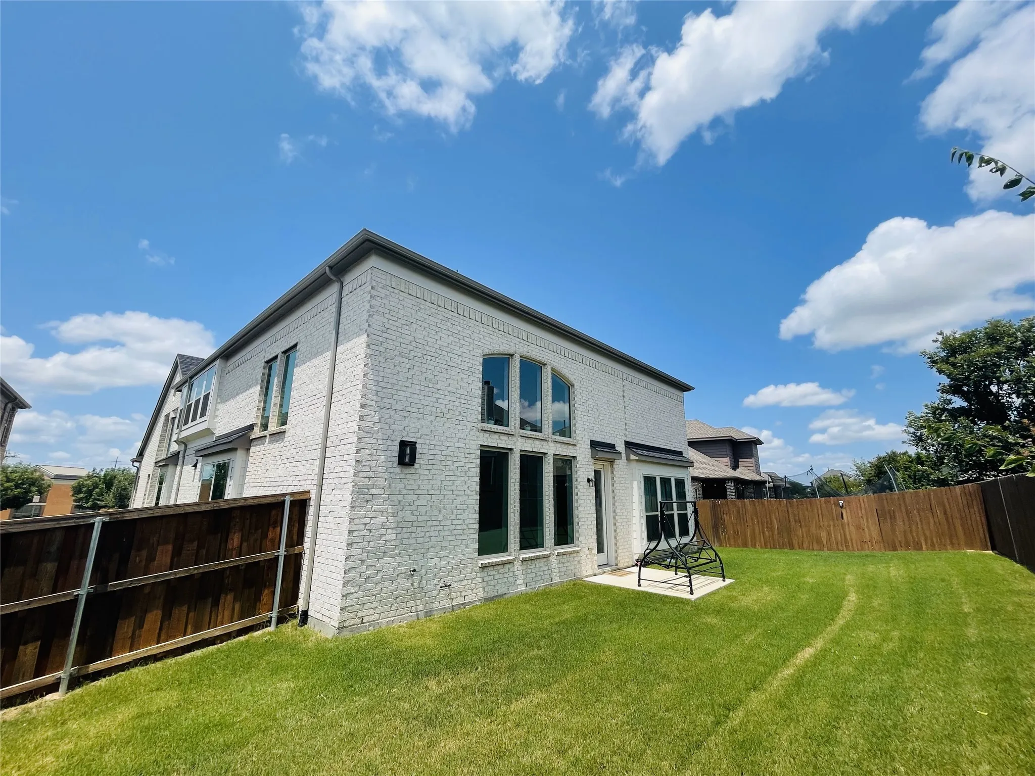 Back of property with a lawn