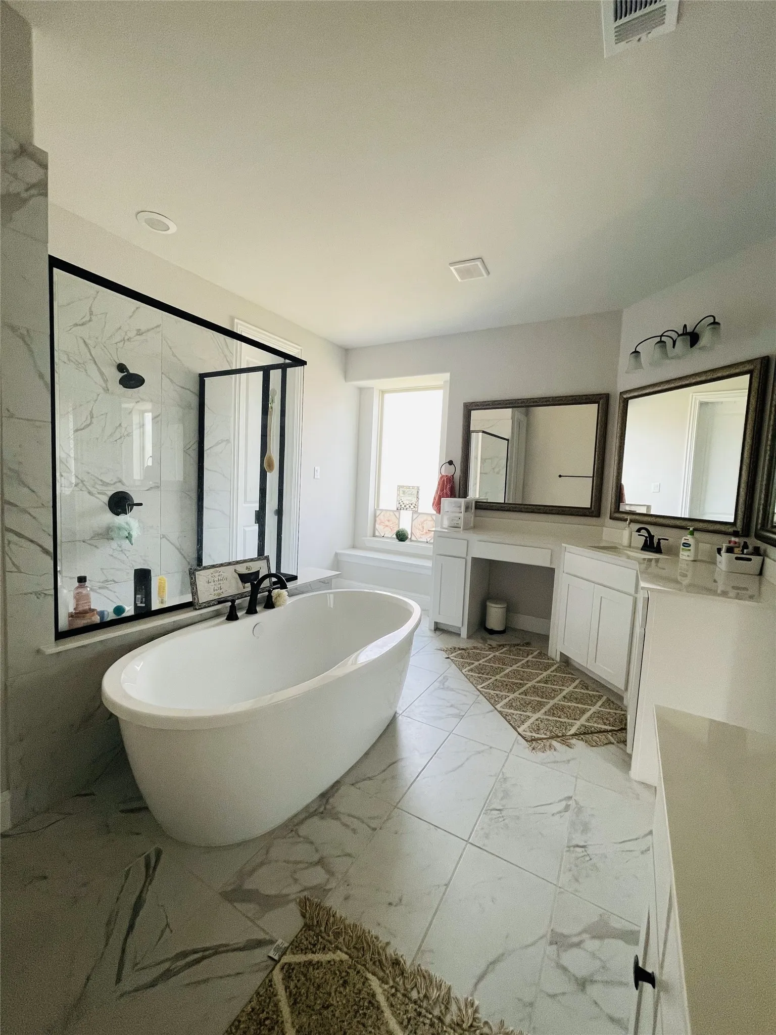 Bathroom with vanity and separate shower and tub