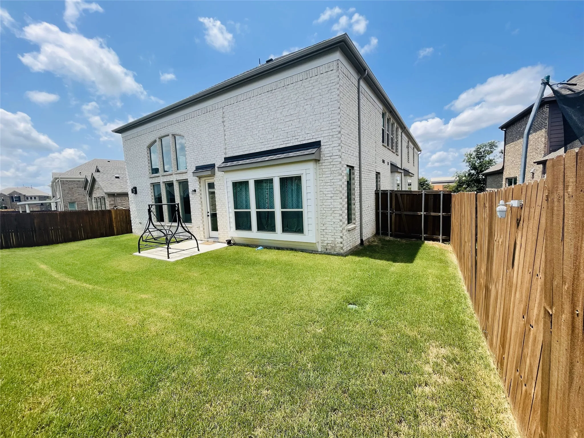 Rear view of property featuring a yard and a​​‌​​​​‌​​‌‌​‌‌​​​‌‌​‌​‌​‌​​​‌​​ patio