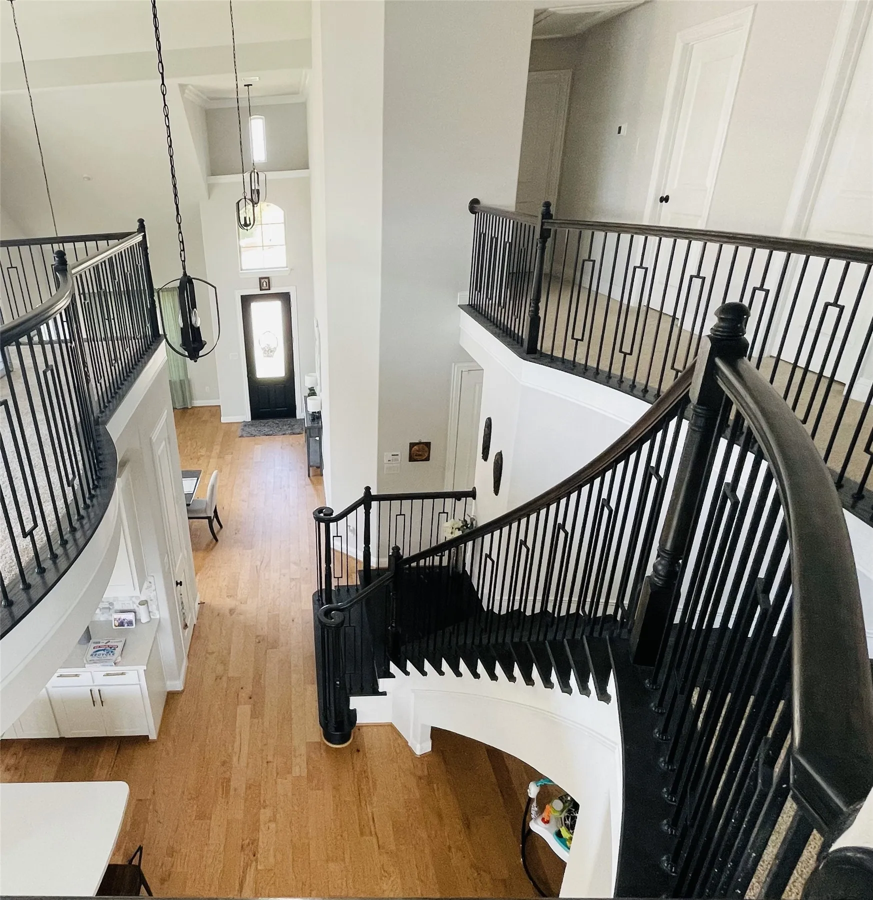 Stairs with a high ceiling and hardwood / wood-style flooring