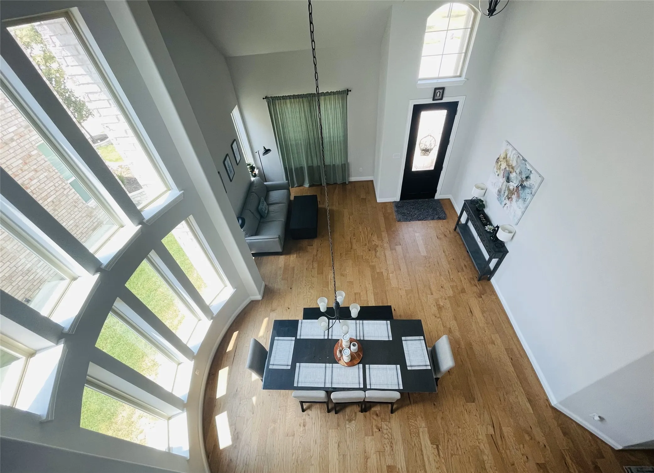 Entrance foyer featuring hardwood / wood-style floors, a high ceiling, and a notable chandelier