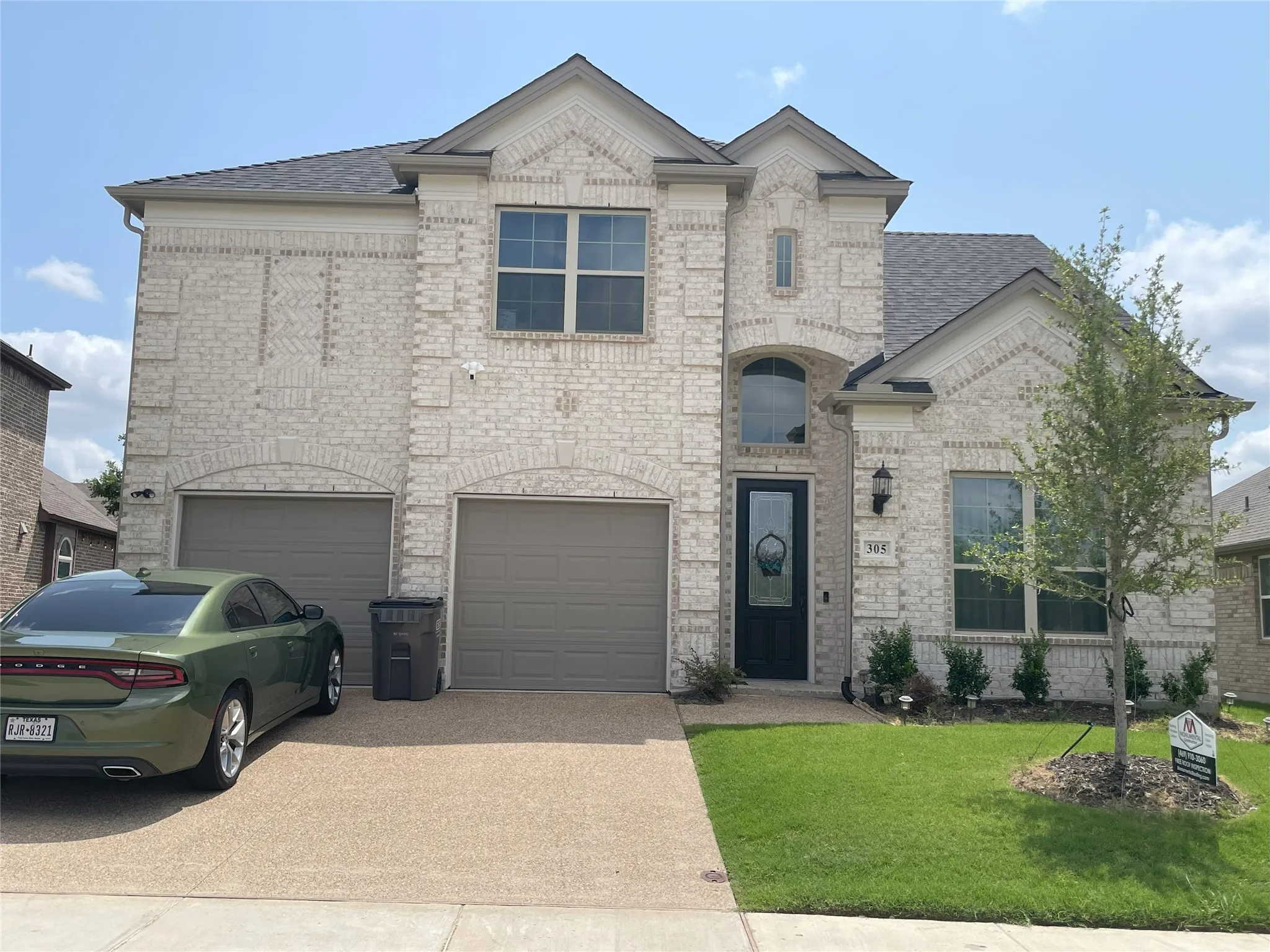 View of front facade with a garage and a front yard