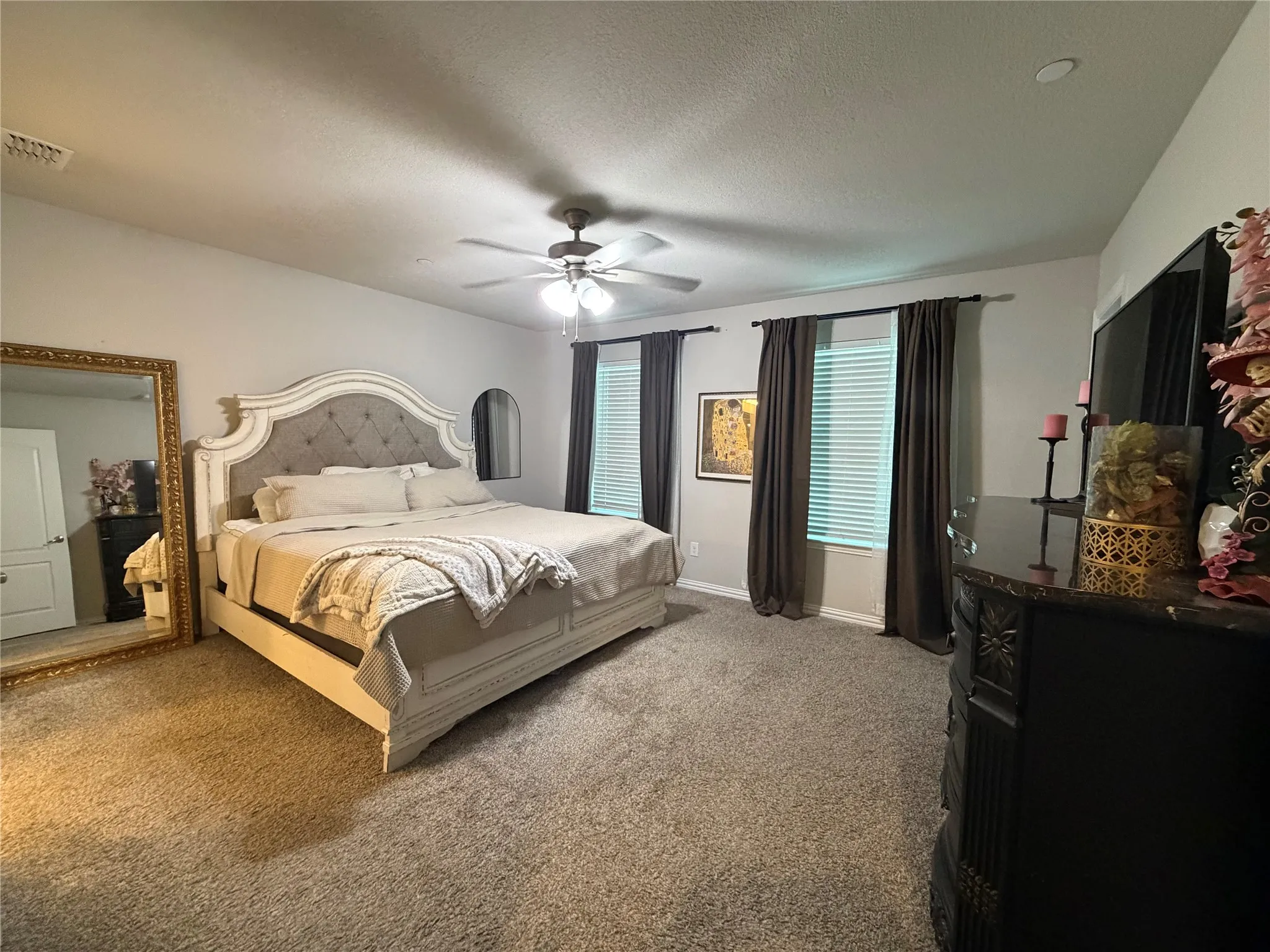 Recessed lighting, ceiling fan, carpeted flooring, and window treatments with blinds